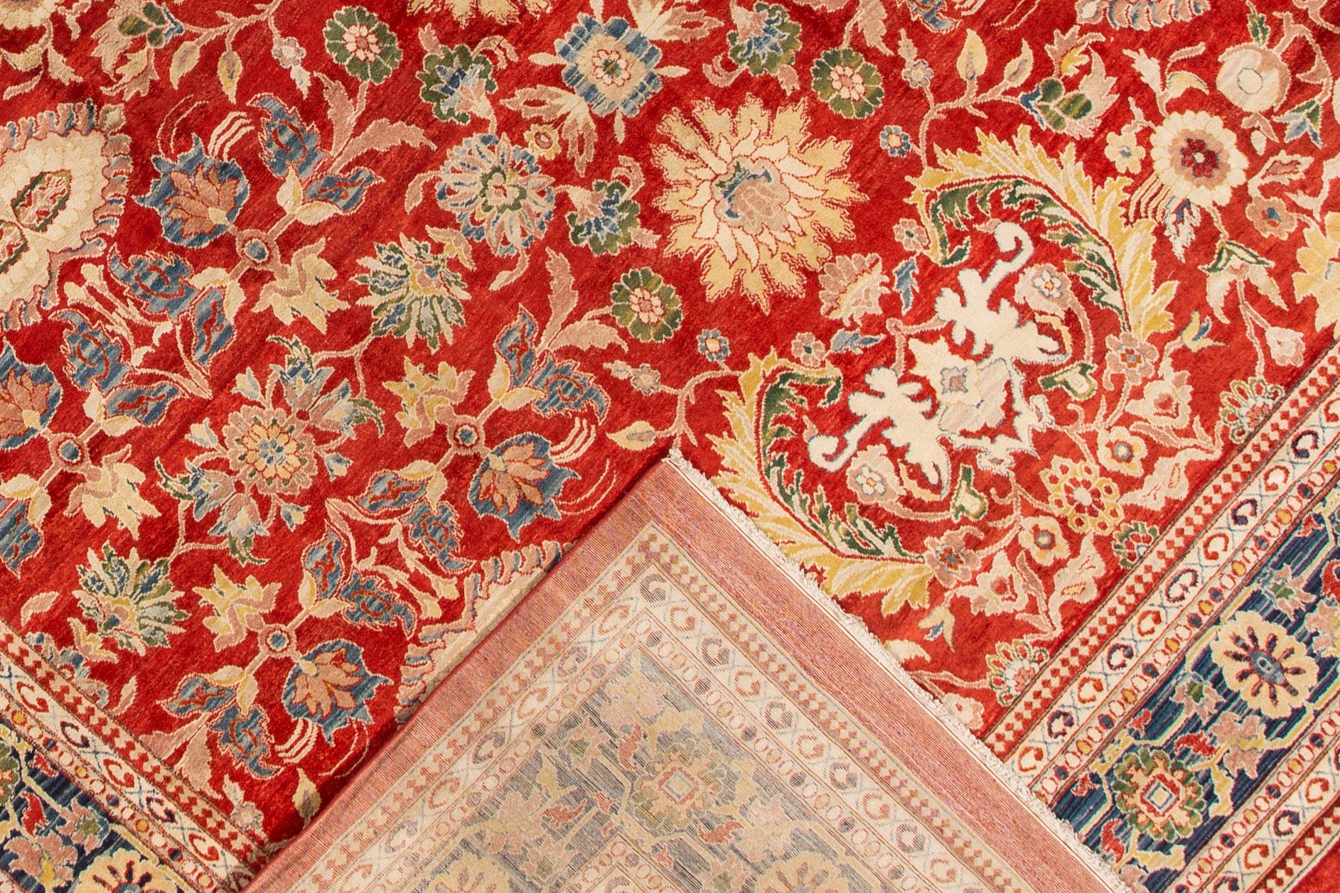 A hand-knotted antique Sultanabad rug with an all-over floral design. This rug measures 14'0