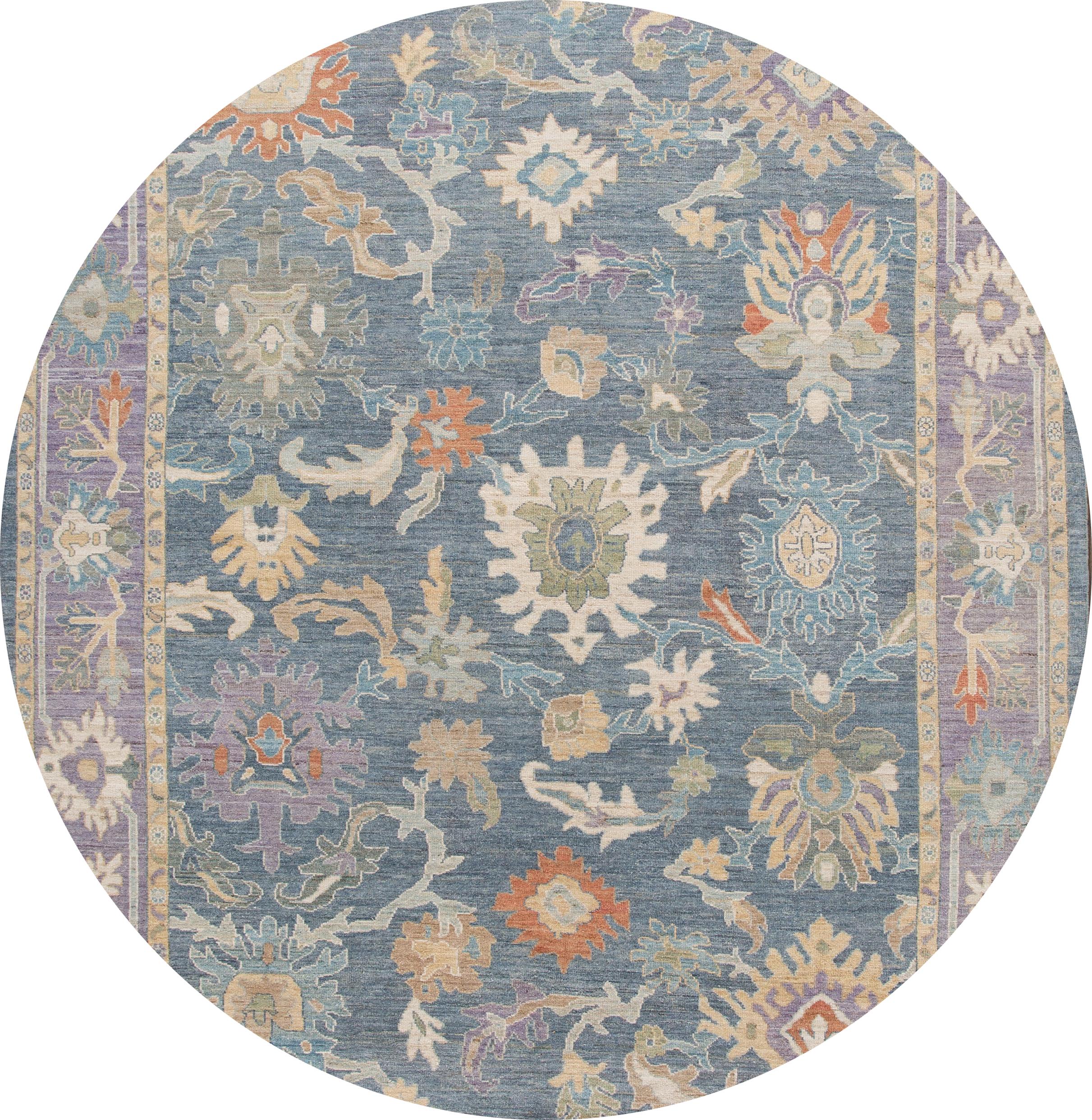 Beautiful contemporary Sultanabad rug, hand knotted wool with a blue field. This rug has a frame of purple and multi-color accents in all-over Classic floral medallion design.

This rug measures: 9'8