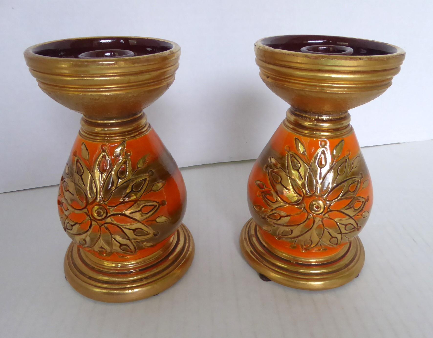 1960s exotic Mid-Century Modern pair candle holders by Aldo Londi for Rosenthal Netter and produced by Bitossi.  Wonderful orange and gold flower pattern, named Sunburst, over a glossy orange glaze with 2 Bronze color bands . The incised design,