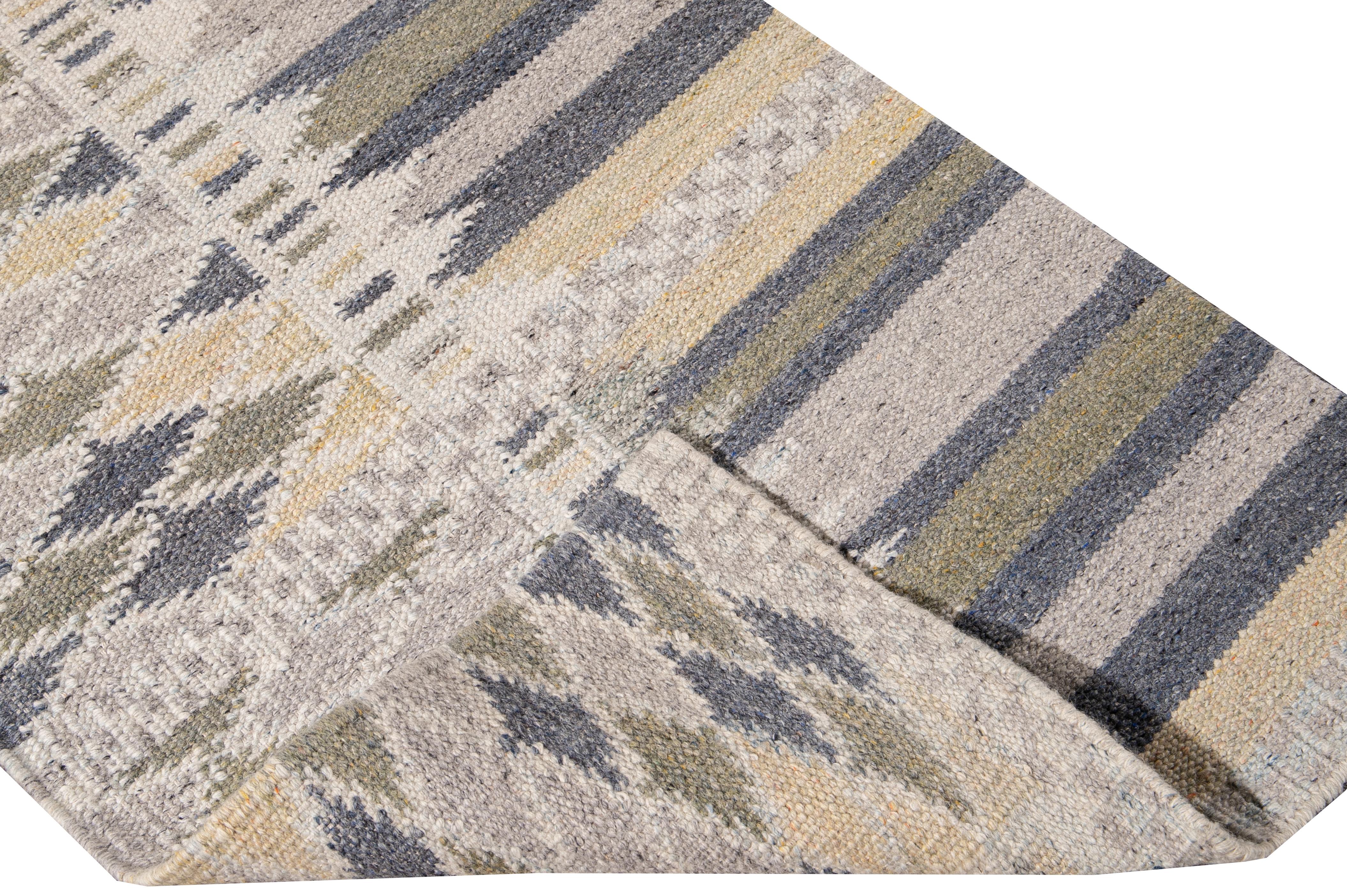 Beautiful modern Long Swedish hand-knotted wool runner with a beige field. This Swedish runner has accents of blue, green, and yellow in an all-over geometric abstract design.

This rug measures: 3'1