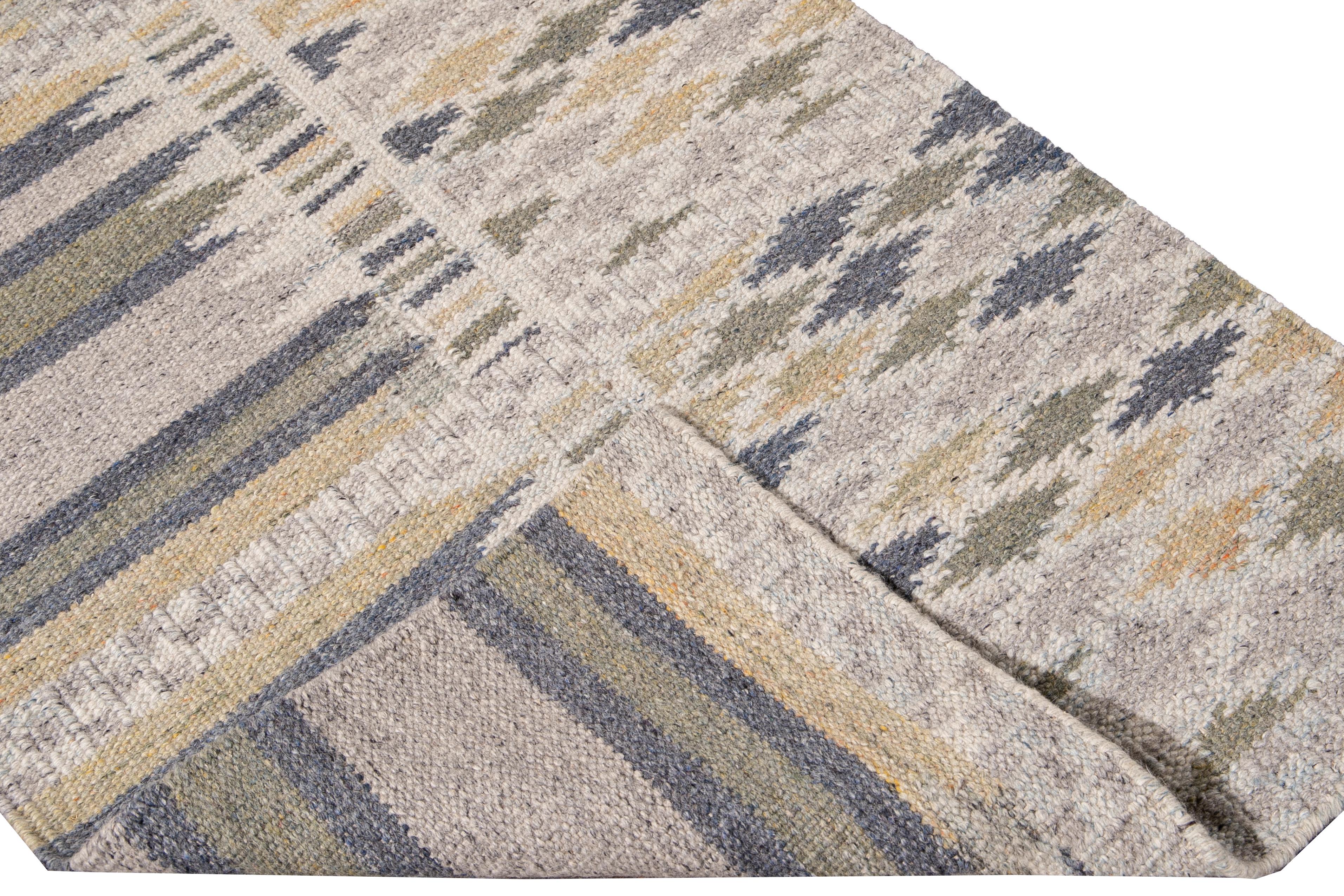Beautiful modern Swedish hand-knotted wool runner with a beige field. This Swedish runner has accents of blue, green, and yellow in an all-over geometric abstract design.

This rug measures: 3'3