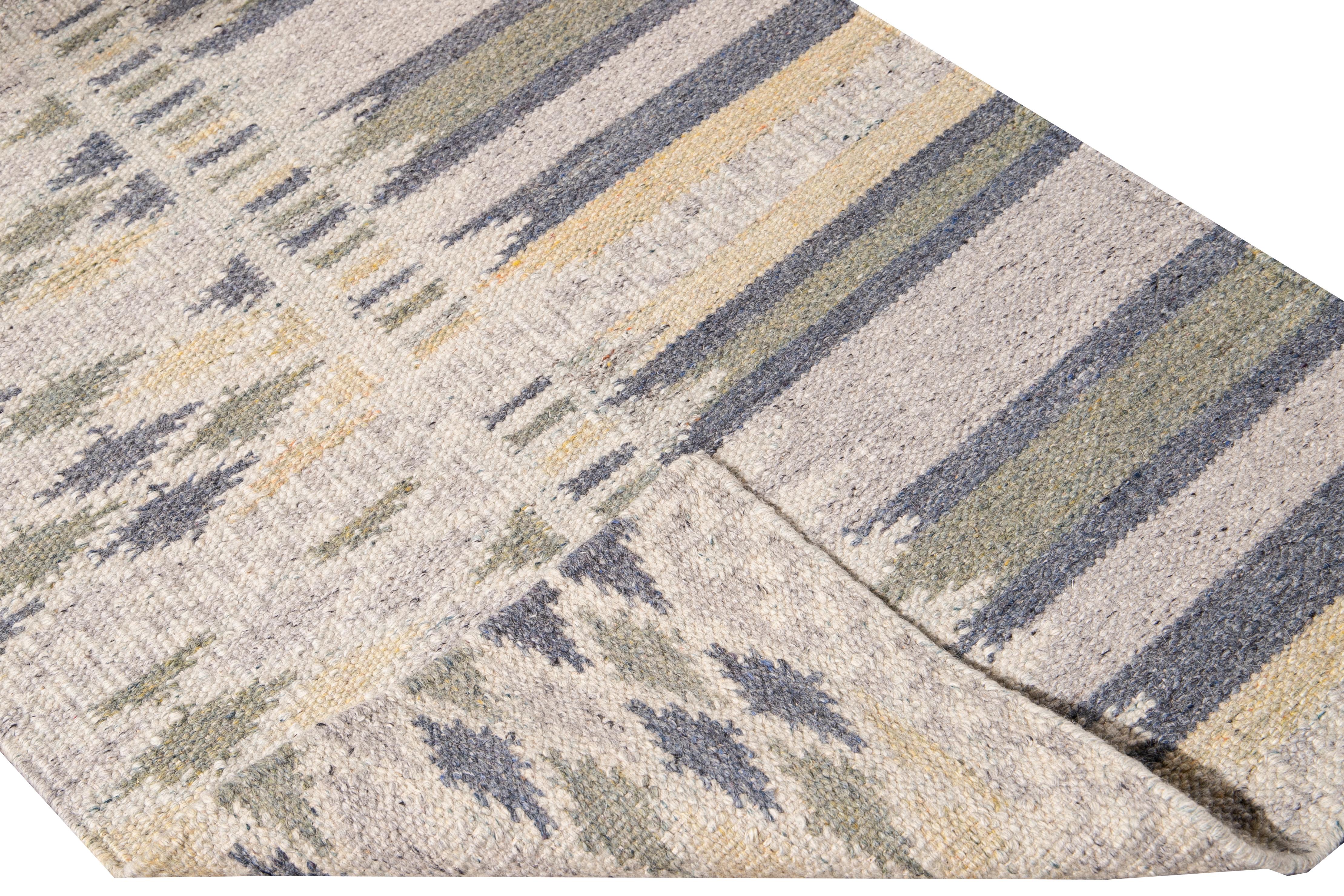 Beautiful modern long Swedish hand-knotted wool runner with a beige field. This Swedish runner has accents of blue, green, and yellow in an all-over geometric abstract design.

This rug measures: 3'2