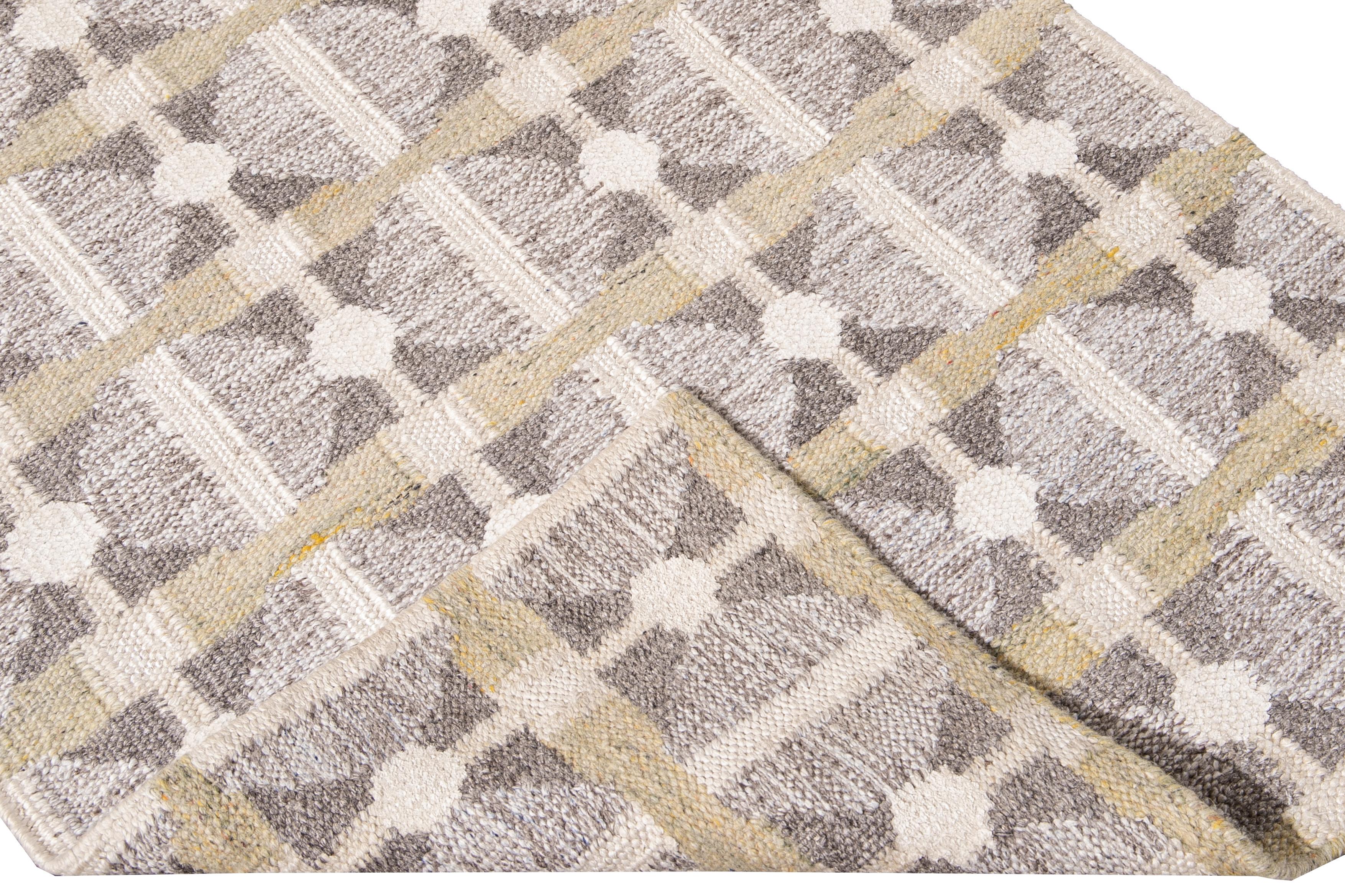 Beautiful modern long Swedish hand-knotted wool runner with a beige field. This Swedish runner has accents of gray and yellow in an all-over geometric abstract design.

This rug measures: 3'2