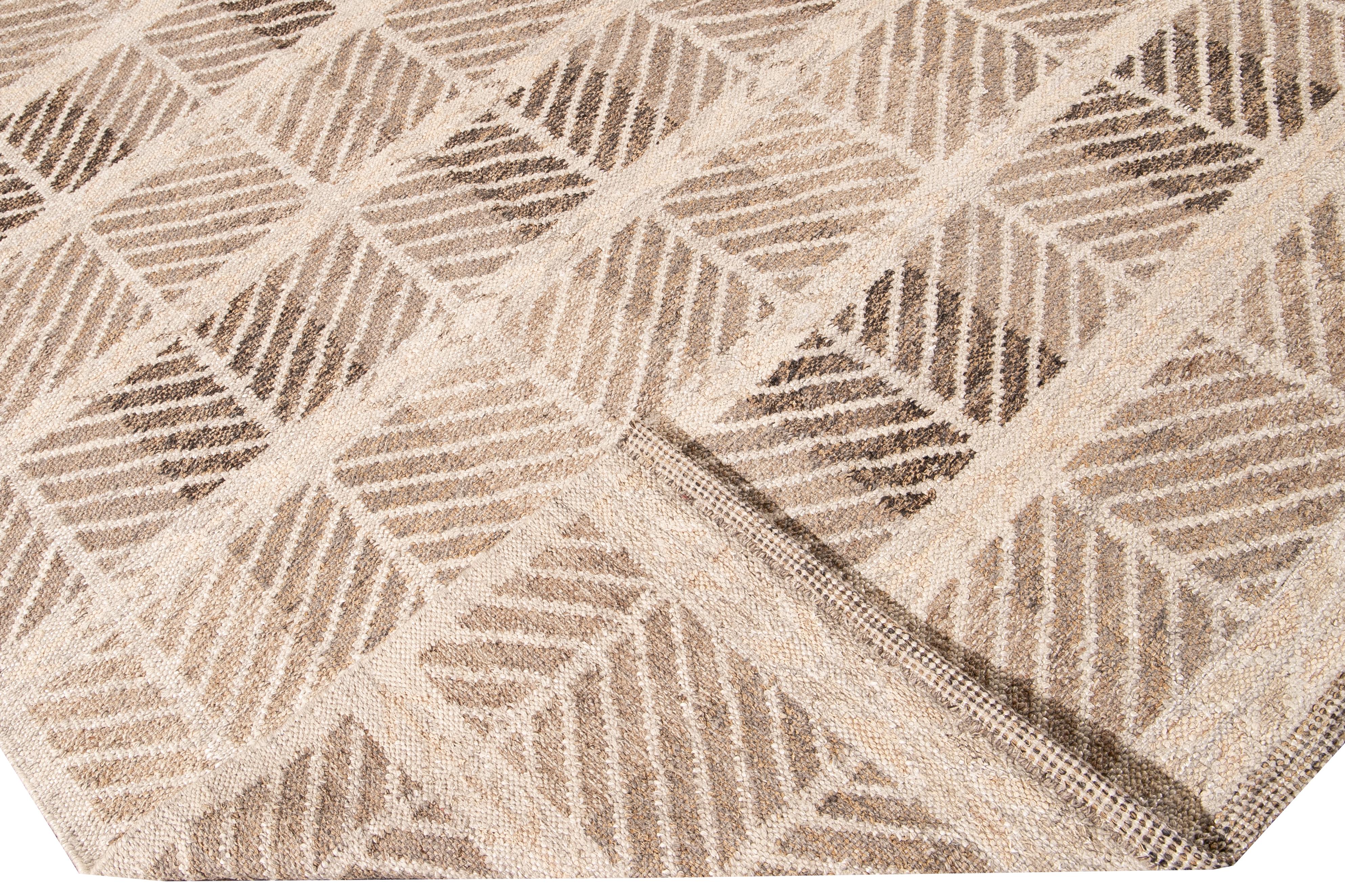 Beautiful Modern Oversize Swedish style wool rug with a beige field. This Swedish rug has accents of brown in a gorgeous all-over geometric pattern design.

 This rug measures: 12'4