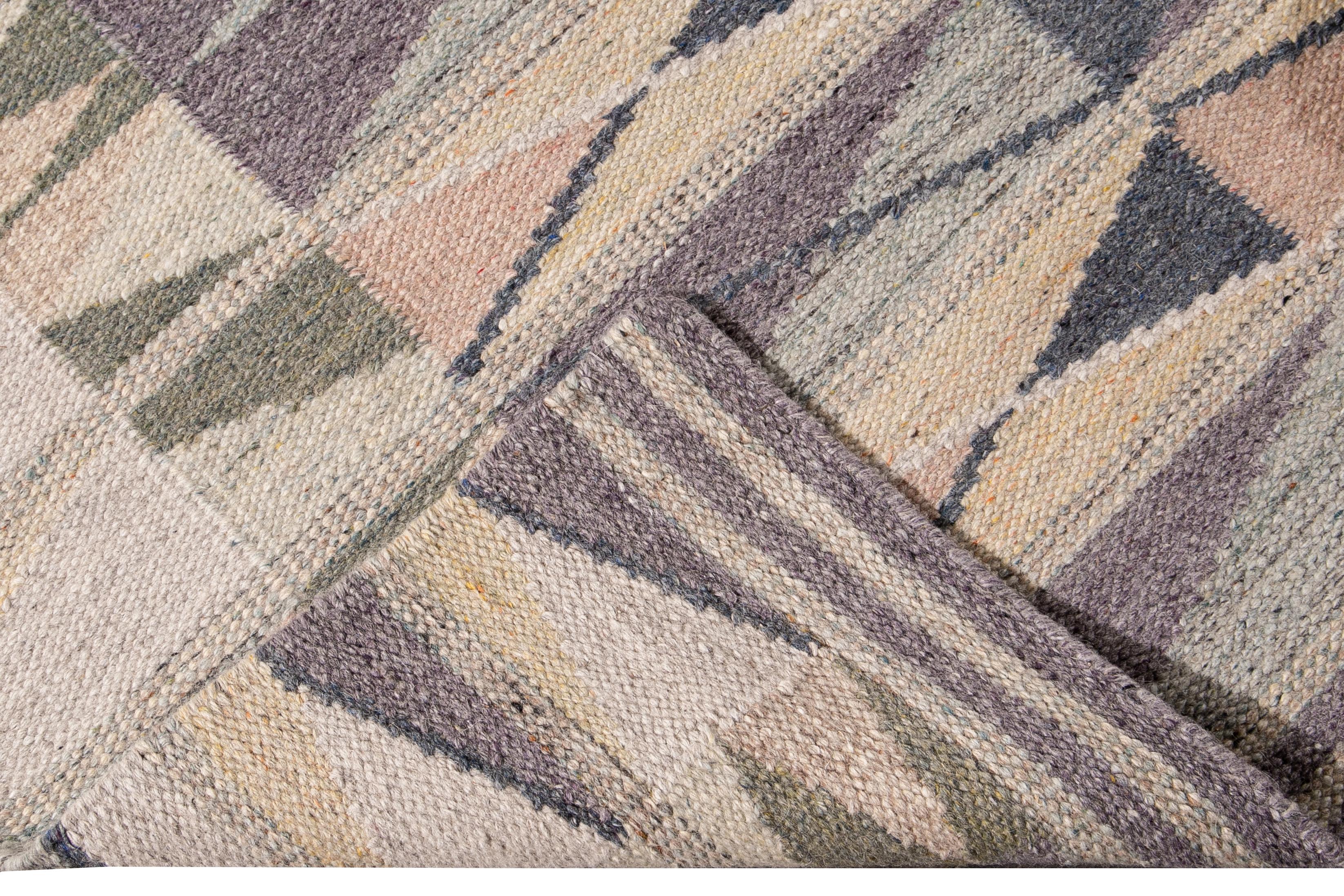 Beautiful modern long Swedish hand-knotted wool runner with a beige field. This Swedish runner has accents of peach, green, and purple in an all-over geometric abstract design.

This rug measures: 3'2