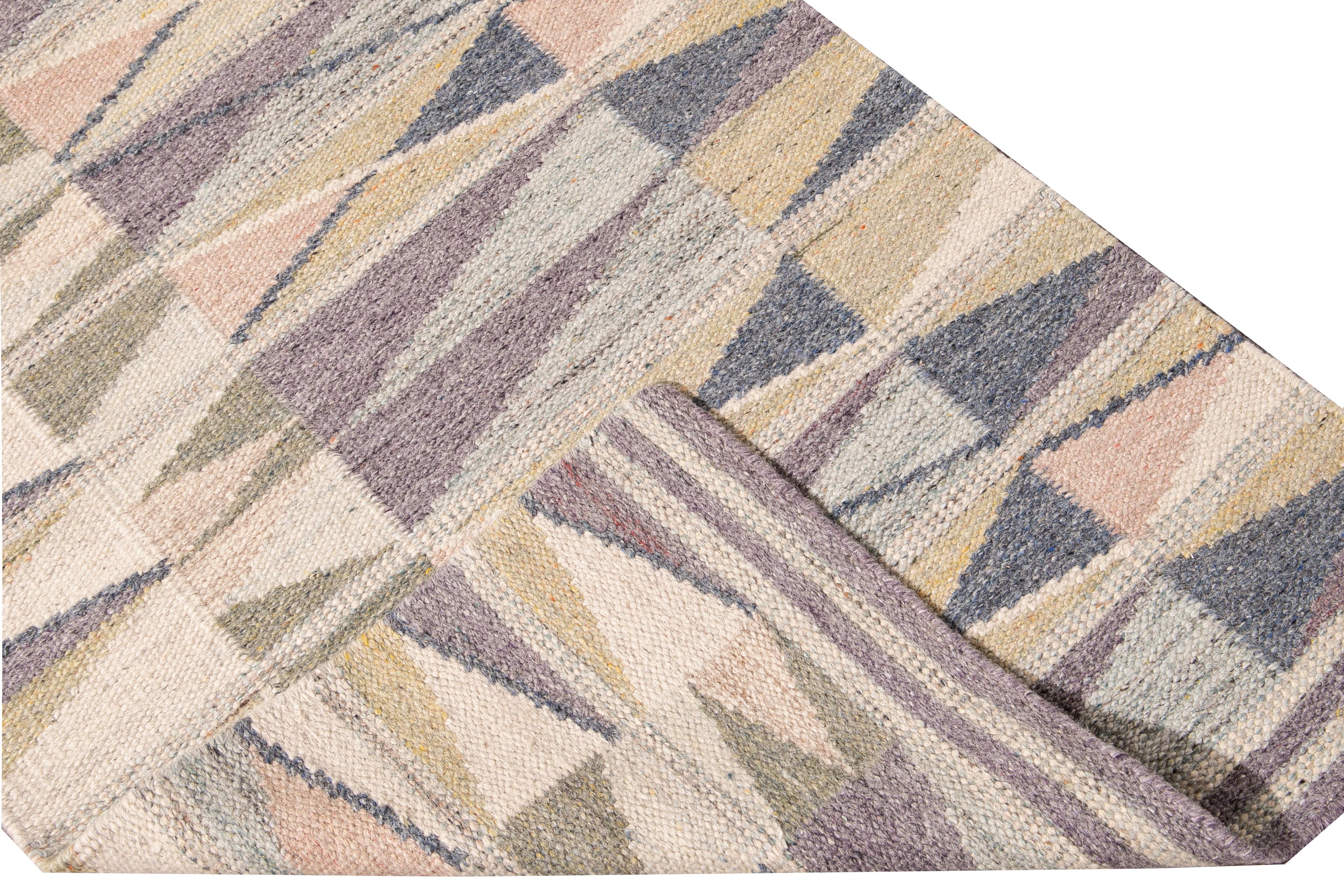 Beautiful modern Long Swedish hand-knotted wool runner with a beige field. This Swedish runner has accents of peach, green, and purple in an all-over geometric abstract design.

This rug measures: 3'2
