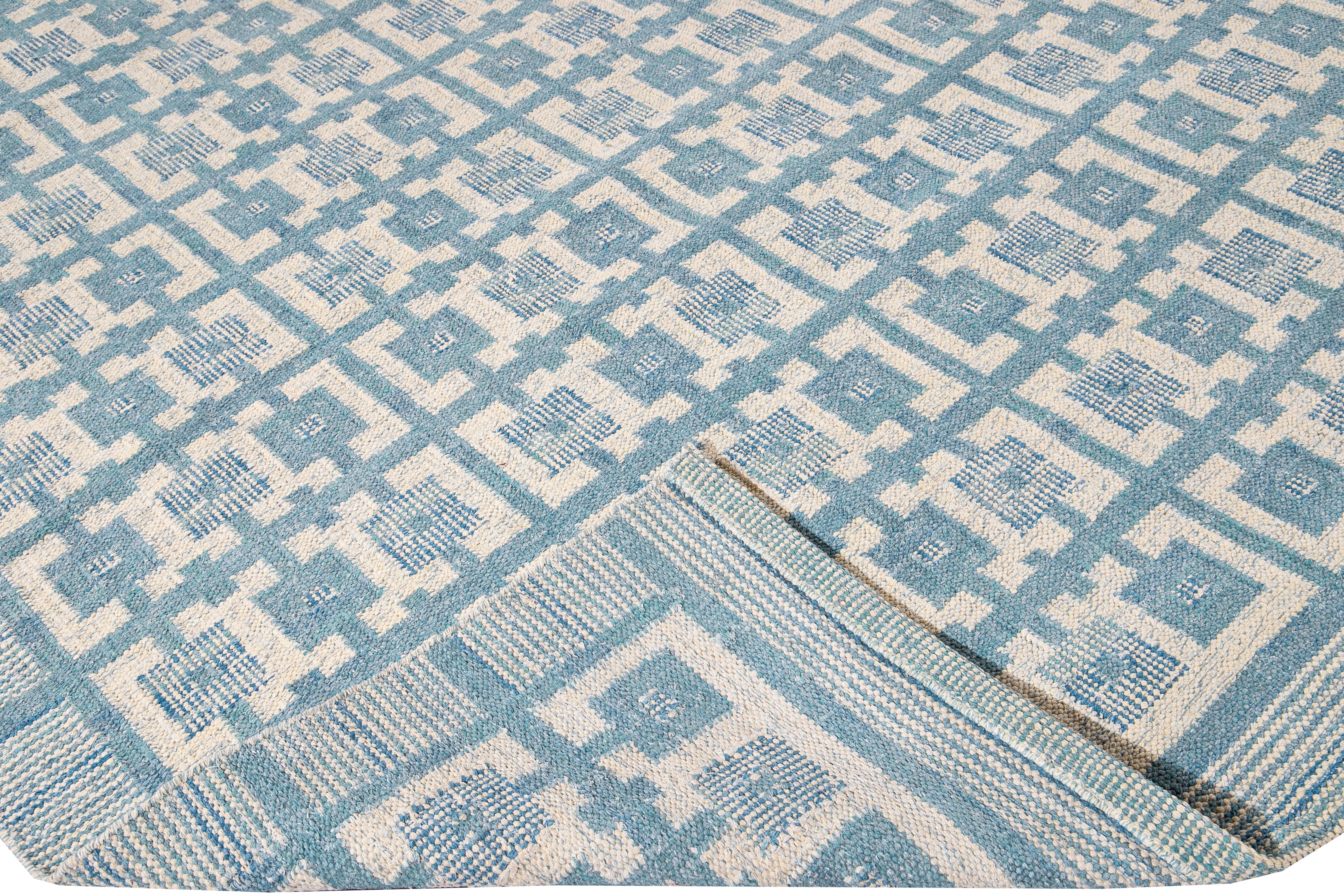 Beautiful Modern Swedish style wool rug with a blue field. This Swedish rug has accents of ivory in a gorgeous all-over geometric square pattern design.

 This rug measures: 10' x 14'.

Our rugs are professional cleaning before shipping.