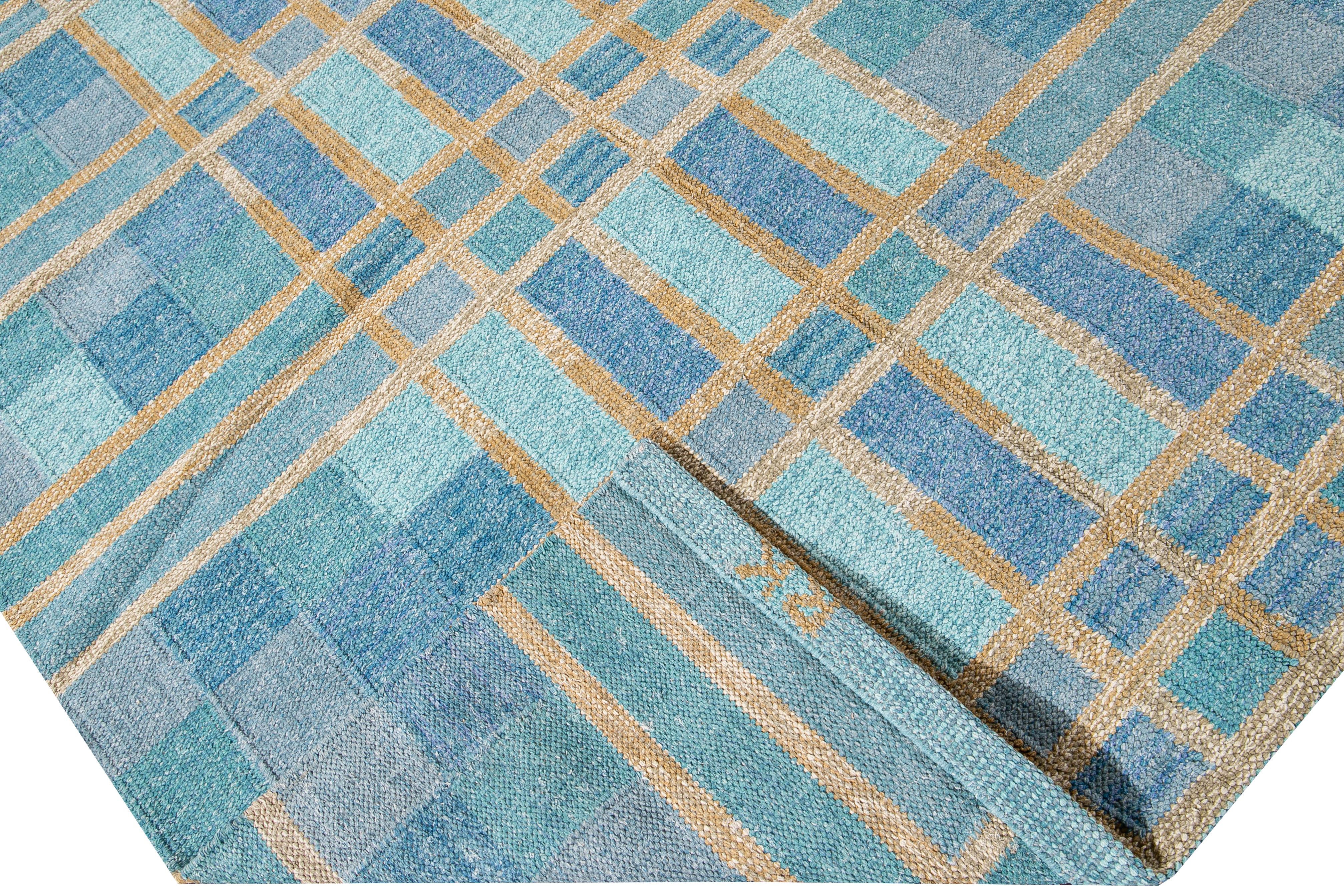 Beautiful modern Swedish style wool rug with a blue field. This Swedish rug has accents of yellow in a gorgeous all-over geometric square checks pattern design.

 This rug measures: 10'1