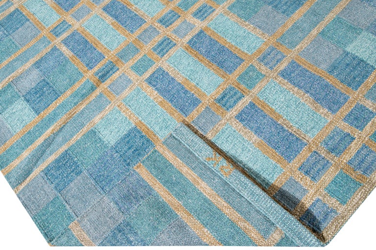 Beautiful modern Swedish style wool rug with a blue field. This Swedish rug has accents of yellow in a gorgeous all-over geometric square checks pattern design.

 This rug measures: 10'1