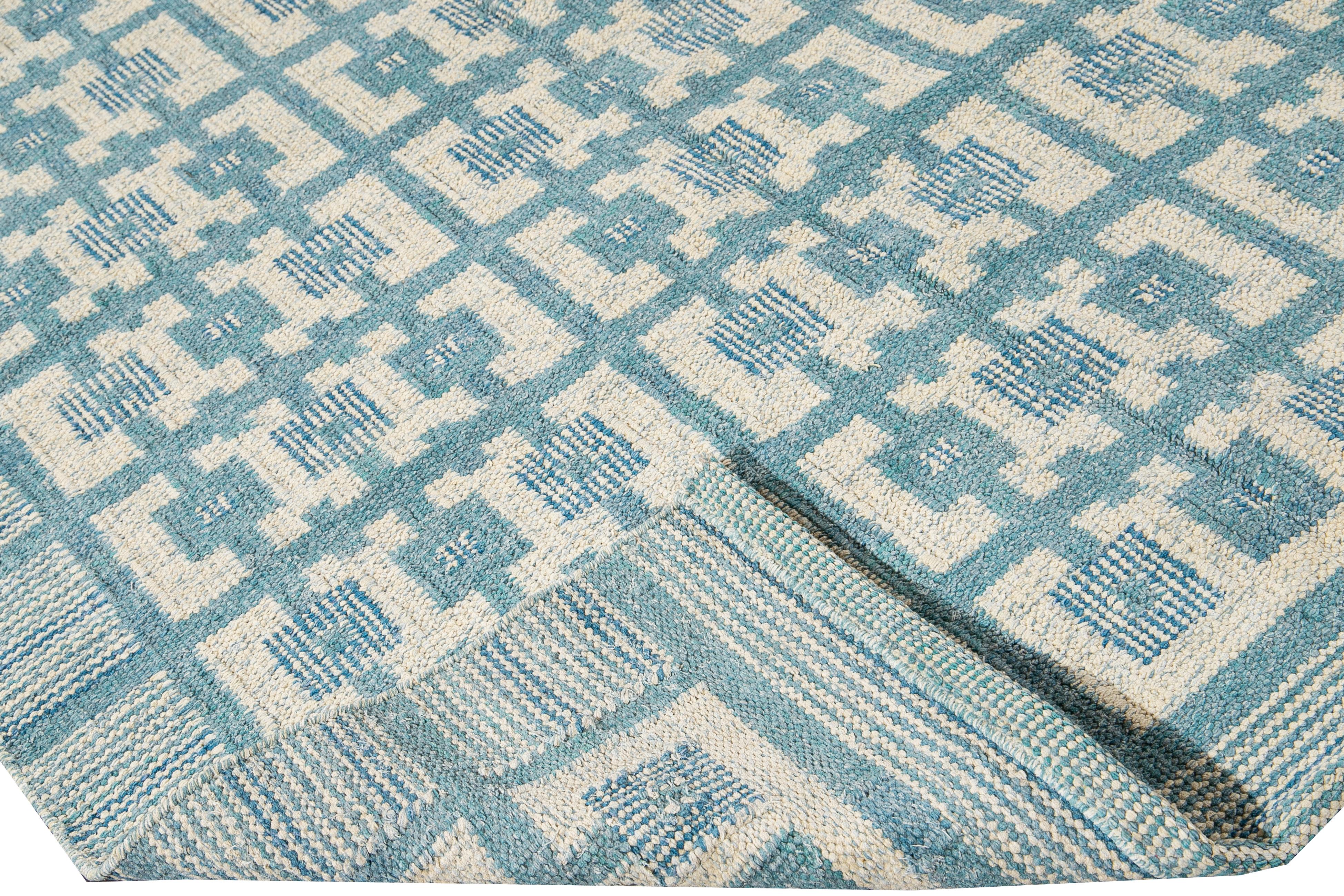 Beautiful modern Swedish style wool rug with a blue field. This Swedish rug has accents of ivory in a gorgeous all-over geometric square pattern design.

 This rug measures: 9'2