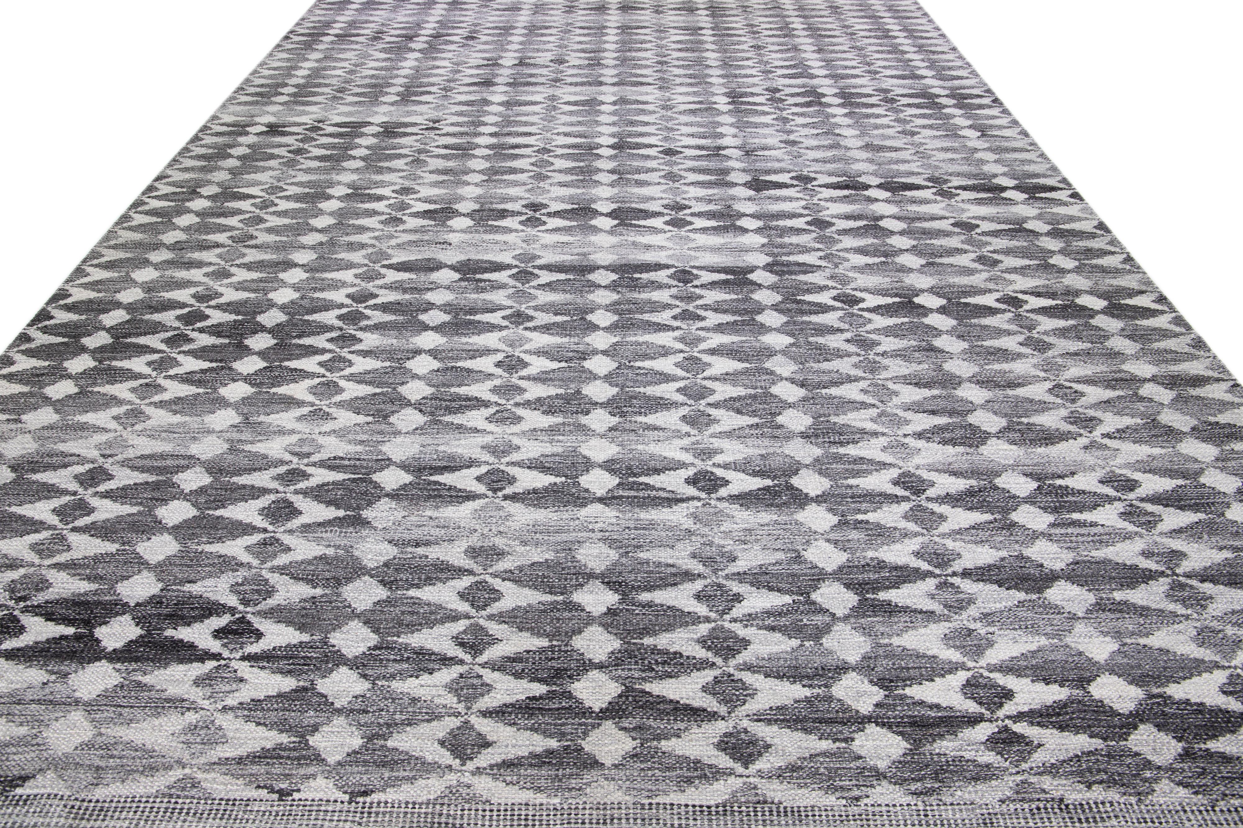 Beautiful modern Swedish-style wool rug with a gray field. This piece has white accents featuring a gorgeous all-over geometric abstract design.

 This rug measures: 12'2'' x 15'2''.

Our rugs are professional cleaning before shipping.