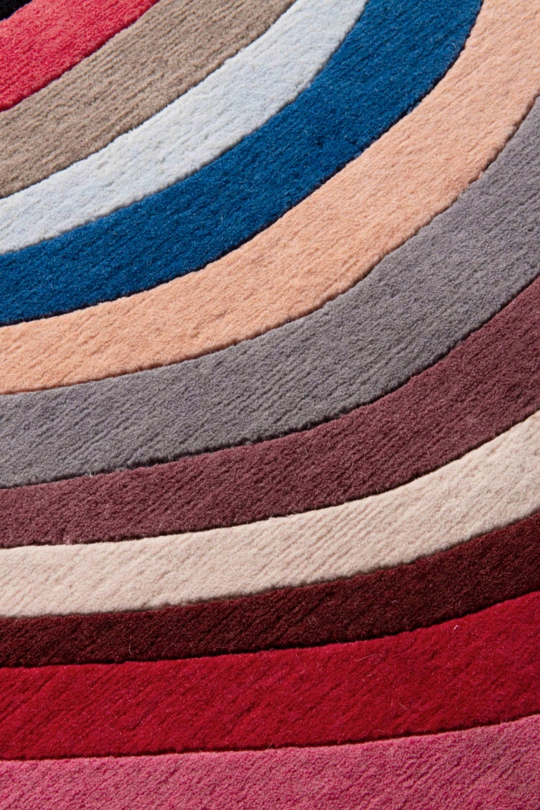 Modern Swirl features the trademark meandering stripe in a multicolour vibrant palette, but with muted jewel tones for ultimate versatility. Each of the colours is carefully calibrated to coalesce rather than clash and is handknotted in finely
