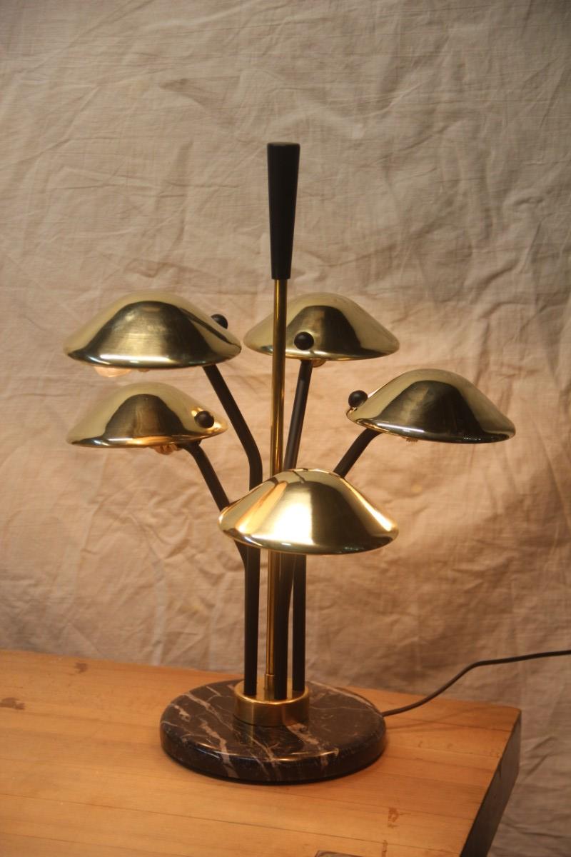 Modern table lamp black and gold brass many mushroom inspired midcentury.

Modern design lamp inspired by the Italian midcentury, it has 5 E14 attack lamps, 15 watt each. Black marble breccia,
elegant and unique piece.
There is possibility of