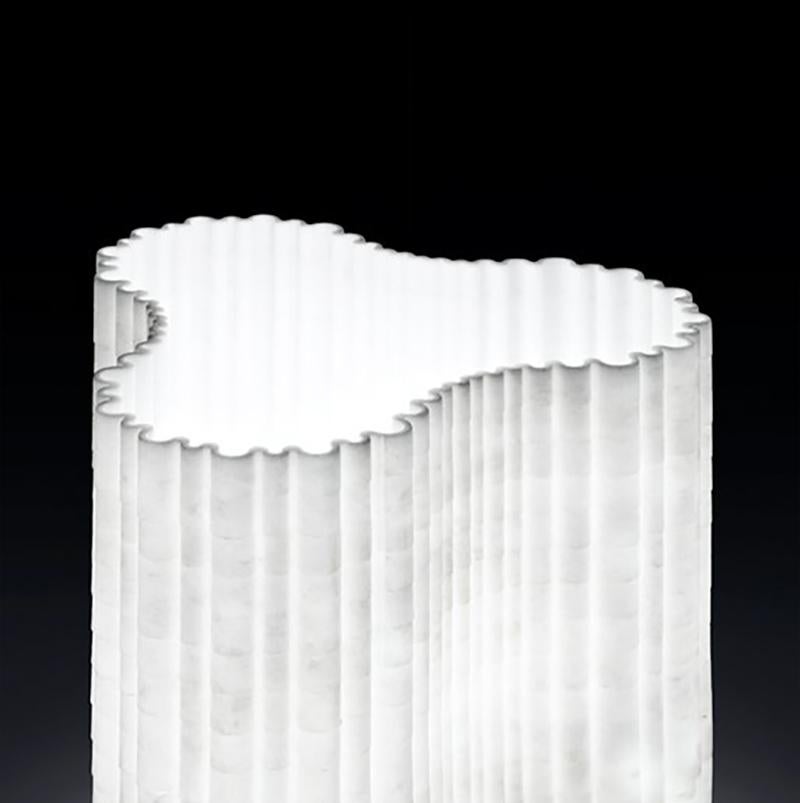 Extremely lightweight and transparent table lamp, with a thickness of just 3 mm designed by Paolo Ulian.

The diffuser and the inner part of the lamp holder are both made entirely of marble. Its shape is created from a 2 cm thick flat slab of marble