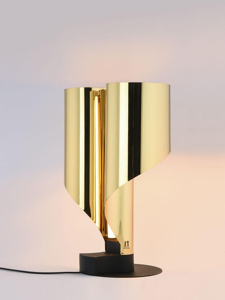 Table light designed in 1968 by Corsini and Wiskemann; this object still retains the charm of its unique values, further defining itself after fifty years, as timeless. The vertical configural development creates the aesthetic form, the bending of