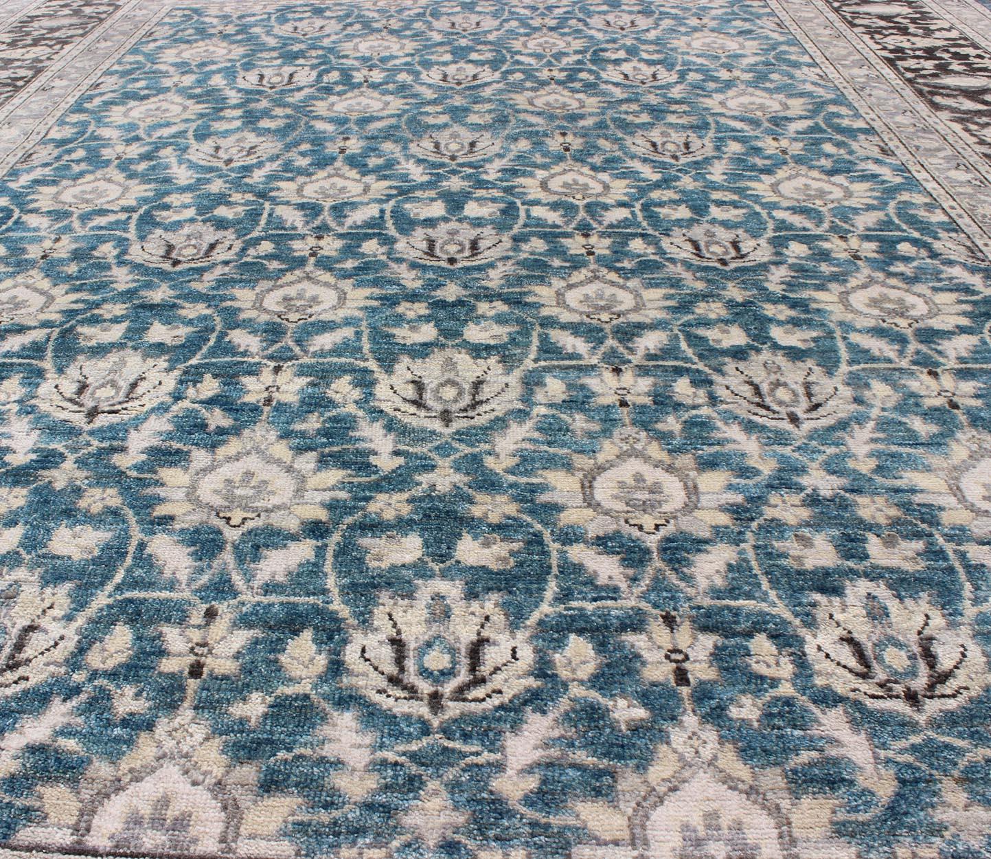 Modern Hand-Knotted Tabriz Rug in Wool with All-Over Design in Blue, Gray and Brown.
Measures: 9'0 x 12'0.
This hand knotted Tabriz rug features a beautiful all-over design rendered in grays, silver, and charcoal and blue tones. The entirety of the