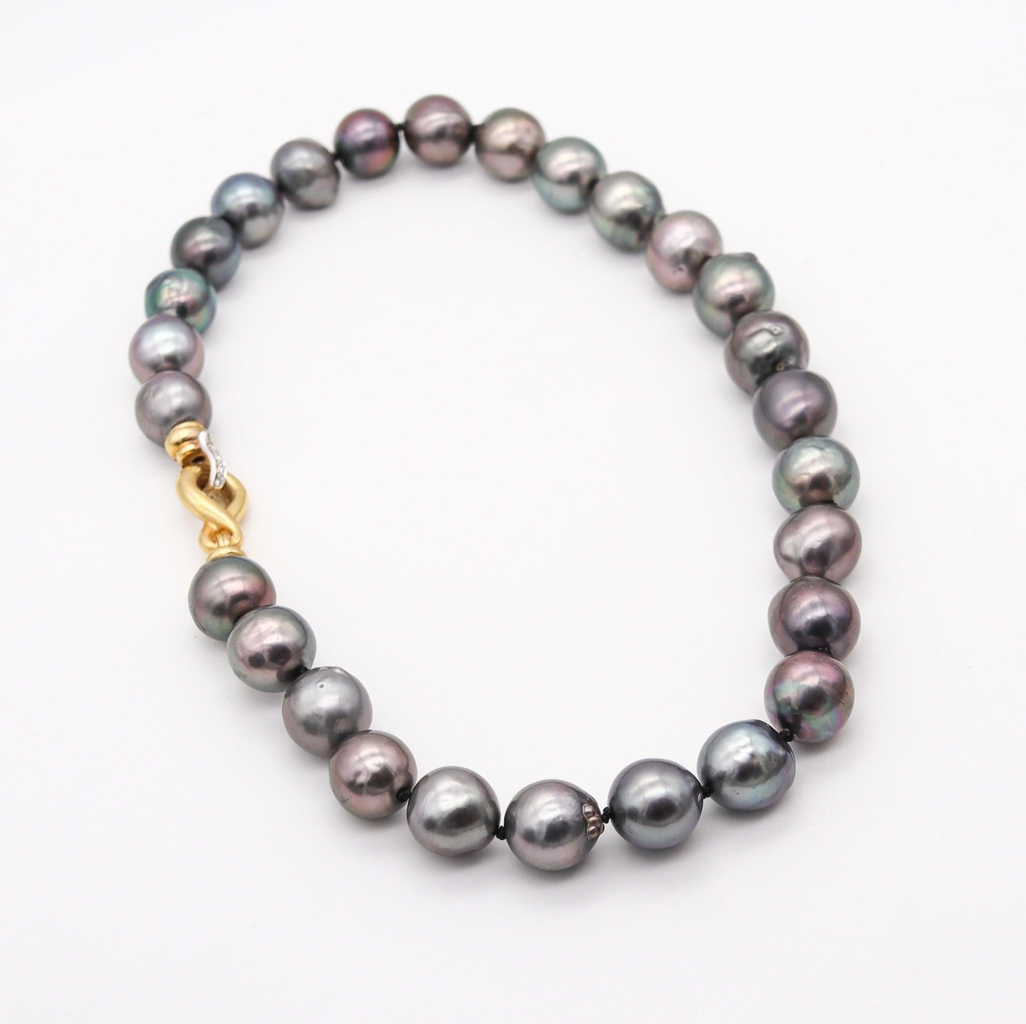 Modernist Italian necklace with Tahitian pearls.

This is a gorgeous statement necklace, created in Italy and stranded with twenty-seven cultured Tahitian black-gray pearls. The strand is securely mounted in a modern luxury security lock crafted in