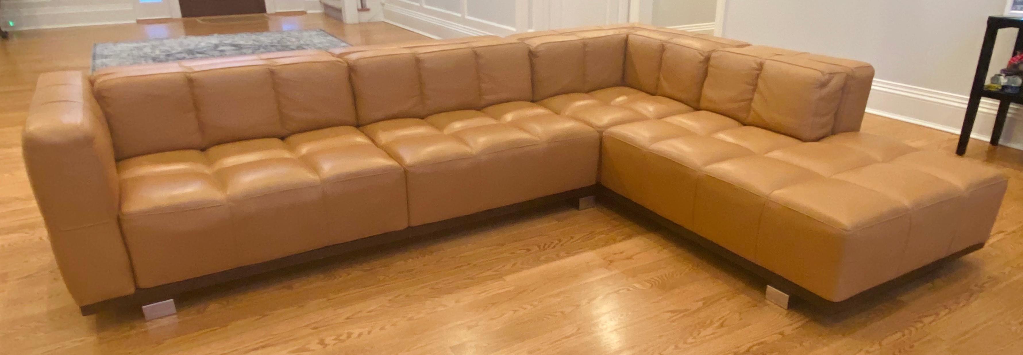 An elegant and stylish sectional soft leather sofa by Roche Bobois ( French, founded 1950) in a fabulous tan or light brown color. The two-piece sofa has a corner composition and a chaise end. The cushions are down filled and are marked Roche Bobois