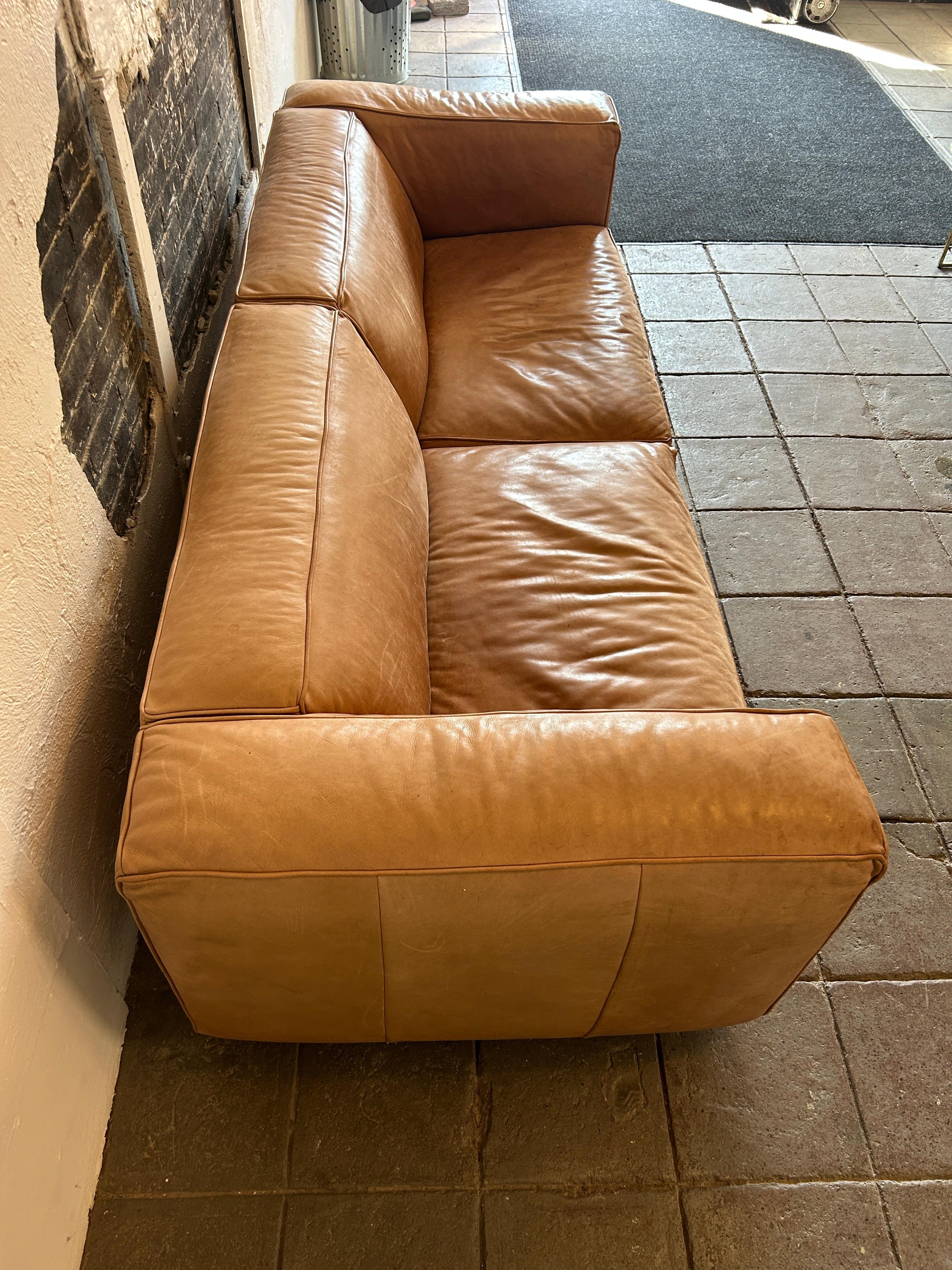 Modern tan leather wide cube sofa on steel tube legs In Good Condition In BROOKLYN, NY