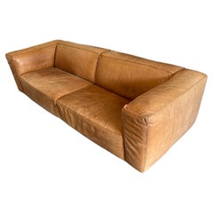 Modern tan leather wide cube sofa on steel tube legs