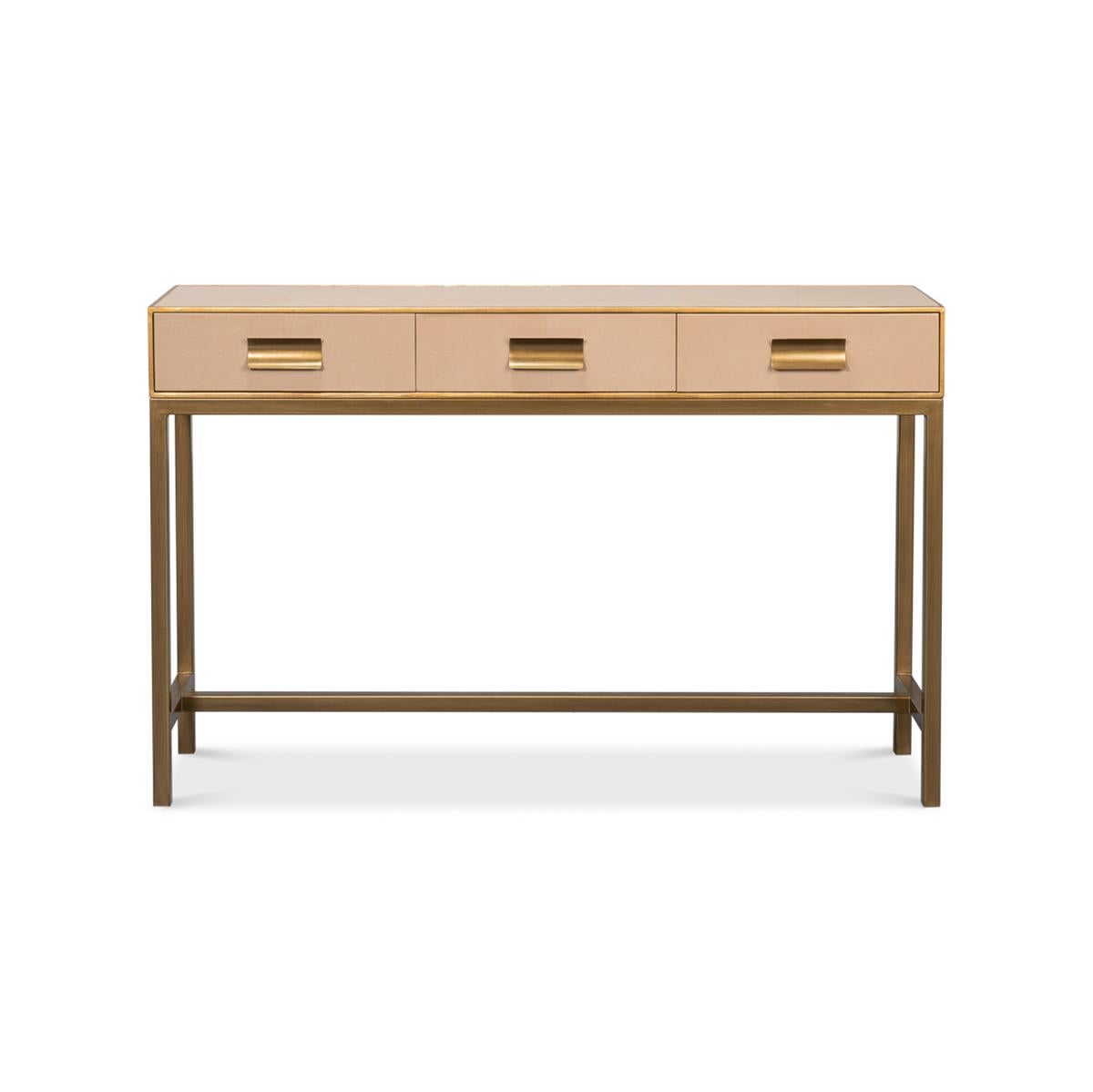 This piece, beautifully crafted with a luxurious creamy mushroom tan leather exterior, is accentuated with delicate gilt trim, adding a hint of glamour to its modern design. The console measures 54