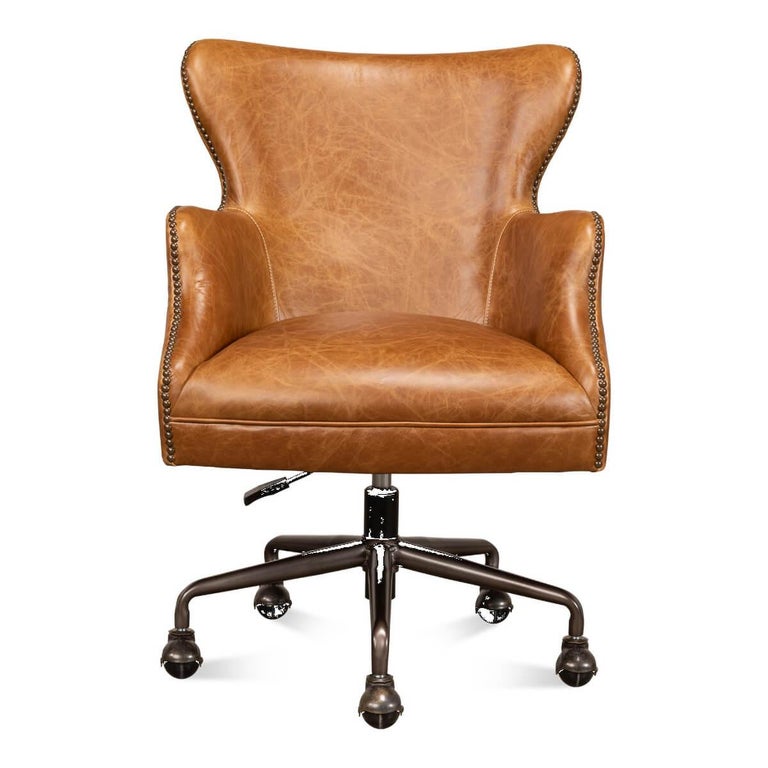 A modern tan saddle leather desk chair with brass nailhead trim. A truly timeless classic style crafted in rich tan leather. This practical and functional chair will elevate the look and feel of any office while you work in comfort. 

Made of