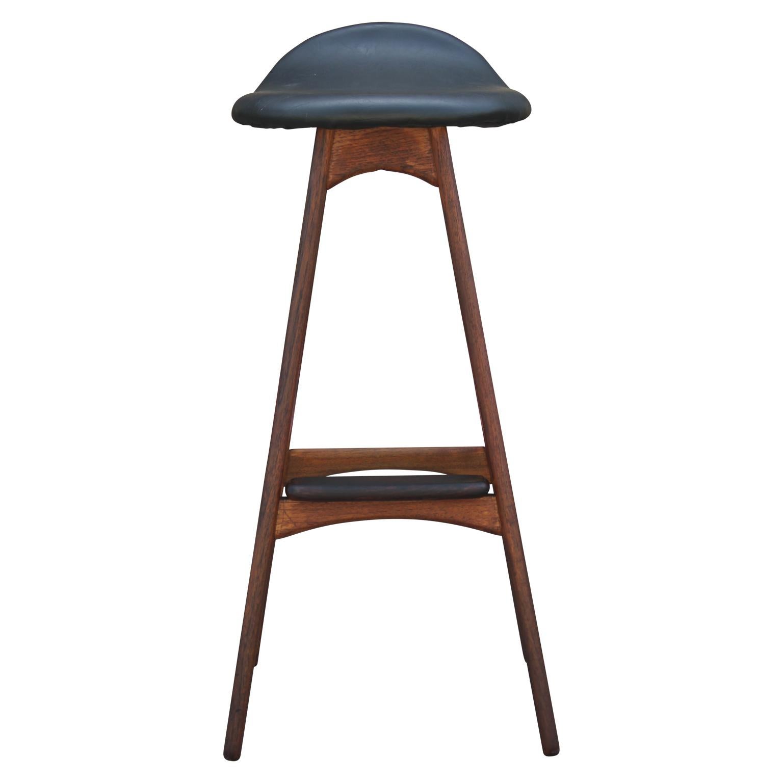 Modern and sleek teak and black leather bar stool with a rosewood foot rest designed by Erik Buck for Odense Møbler. Model OD61.