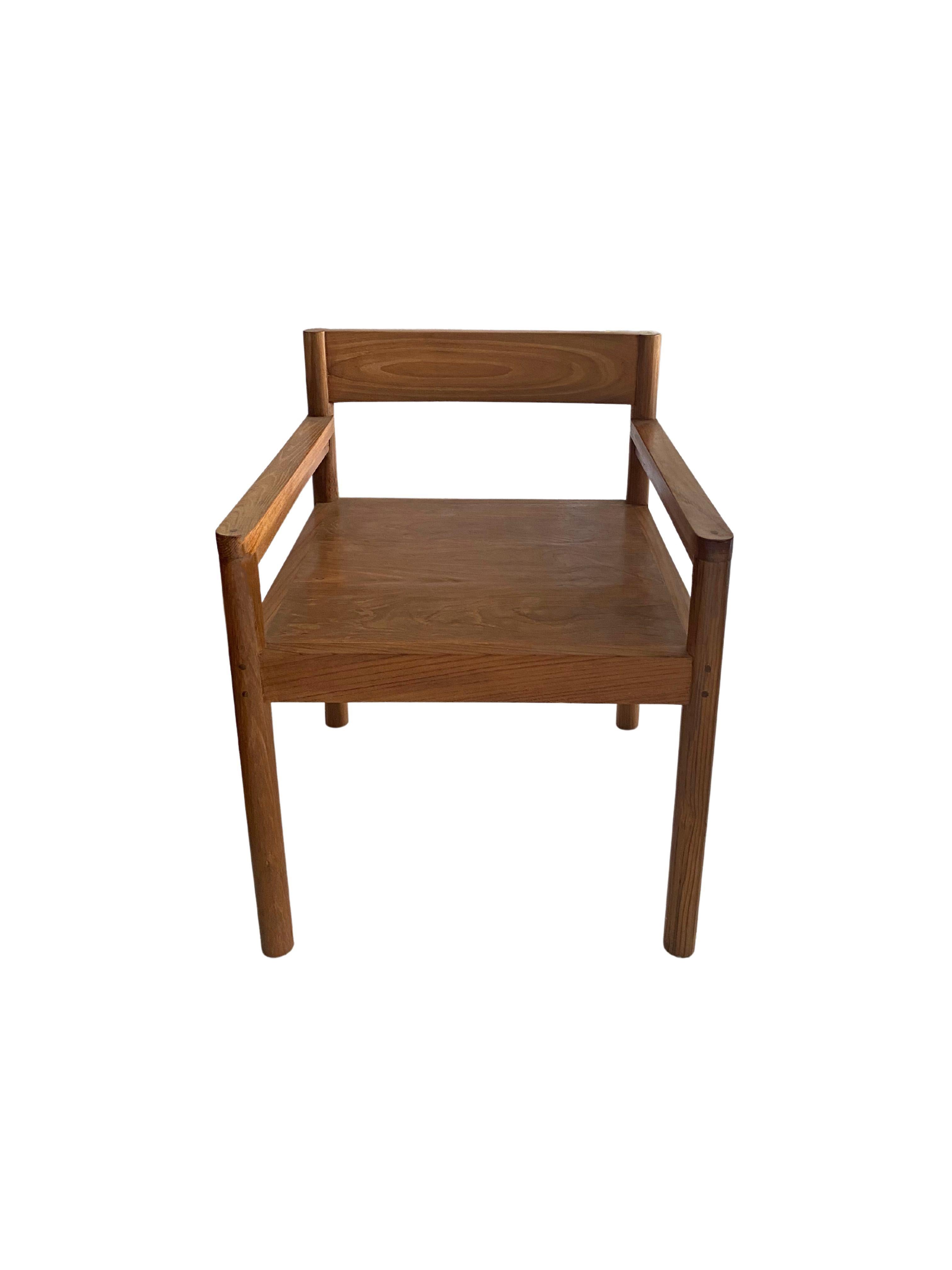 A skilfully crafted teak wood chair. This chair was crafted by local artisans using a wood joinery technique without the use of nails. The chair is wonderfully proportioned with slender arm rests and legs. The teak wood patterning present on all