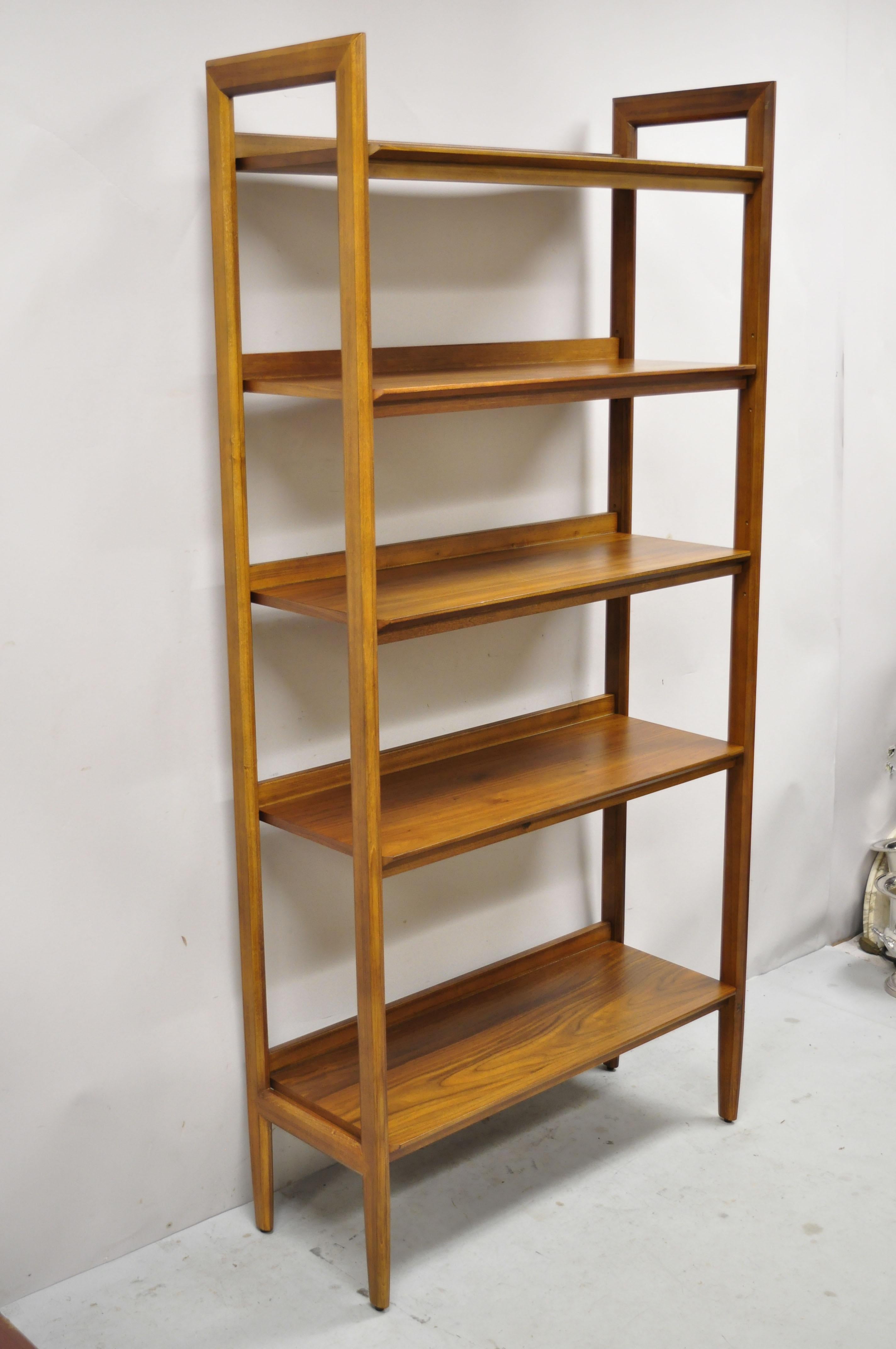 Modern teak wood Danish mid century style 5 shelf tall bookcase stand. Item features (2) adjustable shelves, beautiful wood grain, clean modernist lines, sleek sculptural form. Circa 21st Century, Pre-owned. Measurements: 76