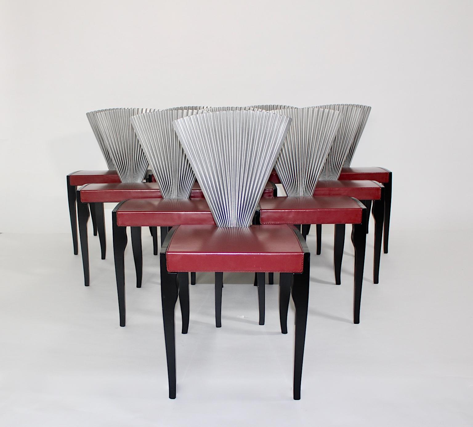 Post-modern style set of ten vintage dining chairs of chairs from beech, leather and metal in the colors red, black and silver designed and made in Italy, 1980s.
Wonderful ten vintage dining chairs, which show black lacquered beechwood frame with a