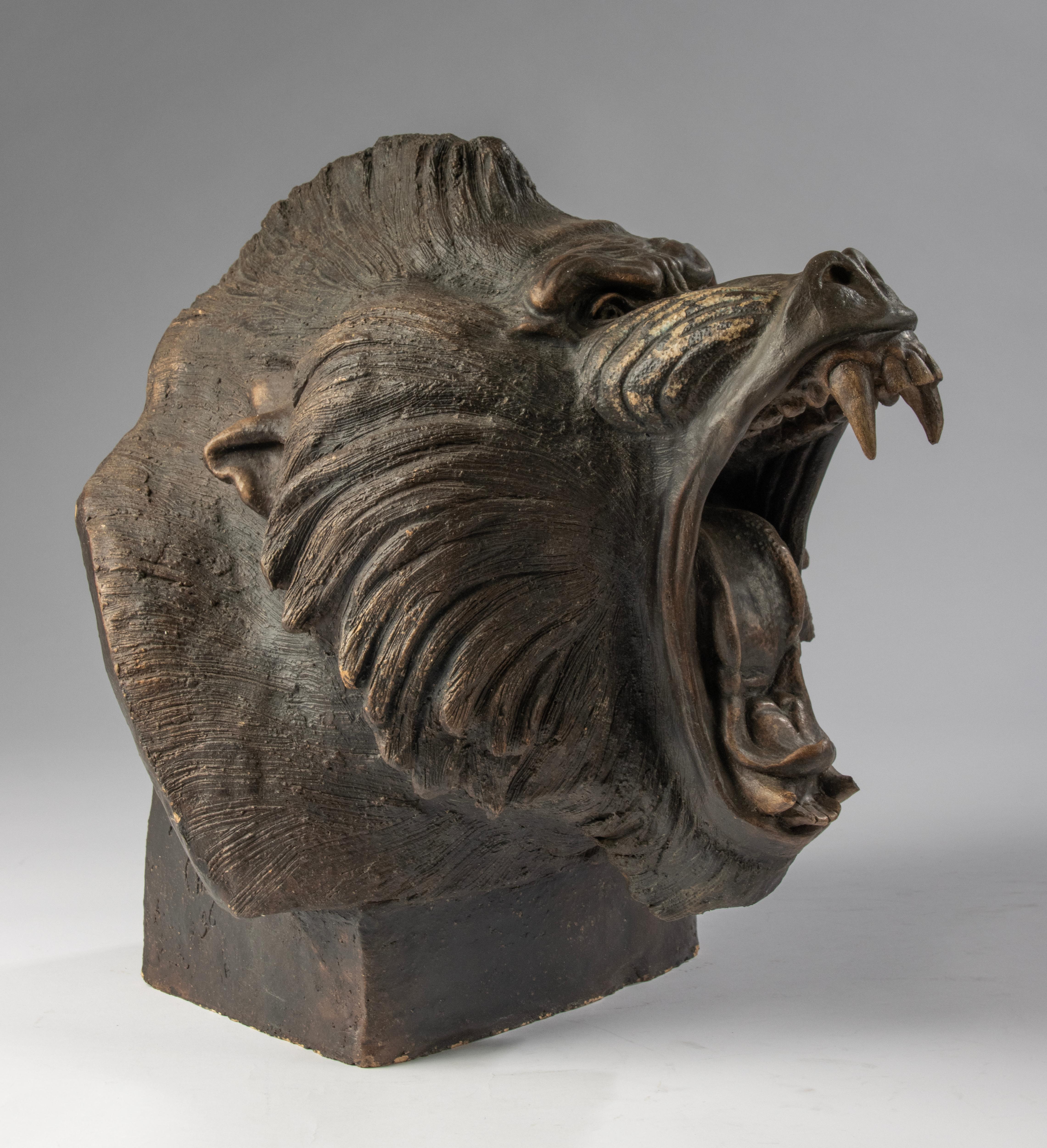 This powerful terracotta sculpture by artist Chen M. is a striking example of modern animalier art. The baboon is not shown in a sweet or docile posture, but rather in a raw, primal stance – mouth wide open in a roar, muscles tensed, fangs bared.