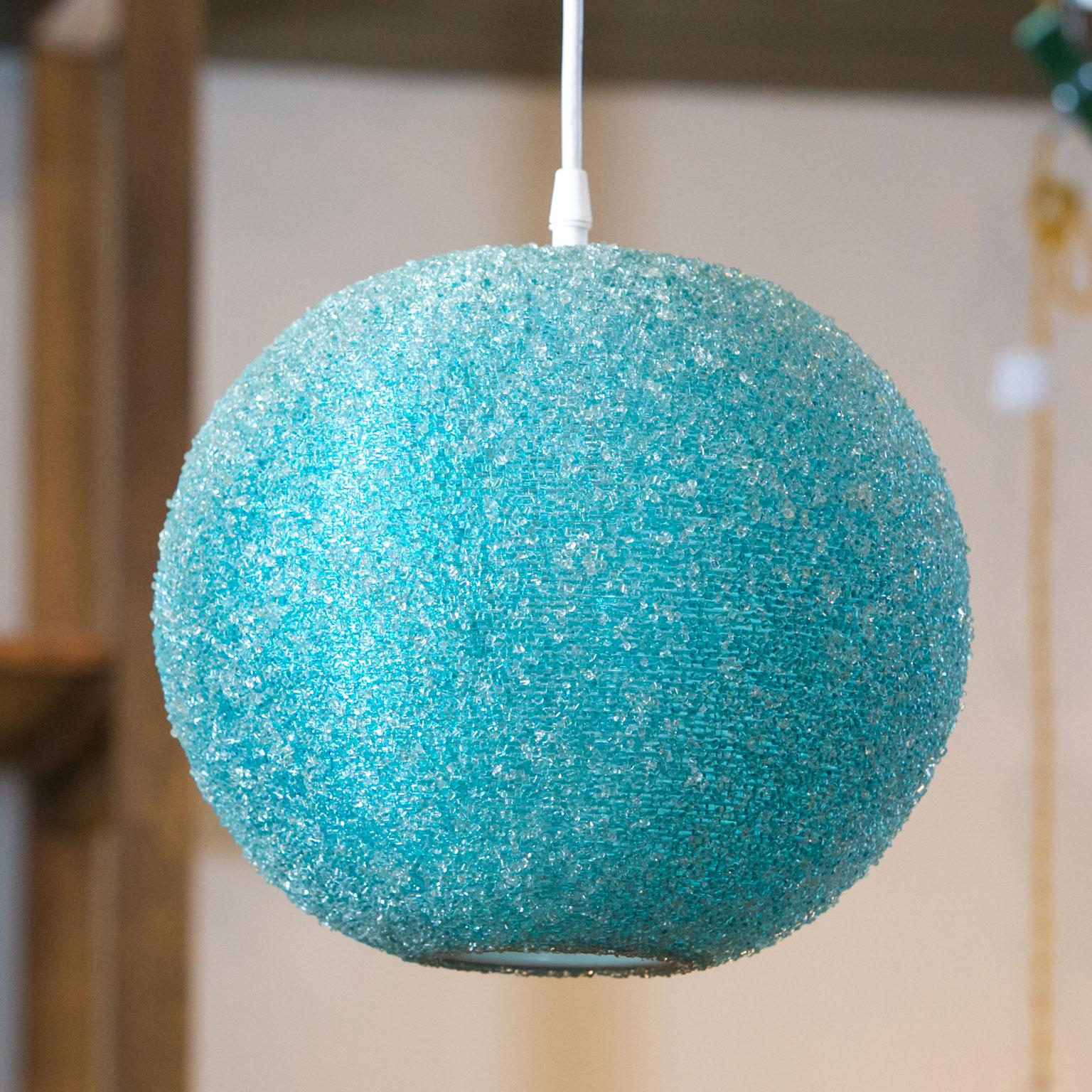 Modern textured globe-shaped light fabricated in plastic resin. This fun light might be interesting in a modern or coastal setting. This light is ball-shaped and looks like a full moon when lit. Newly wired for use within the USA. Includes white