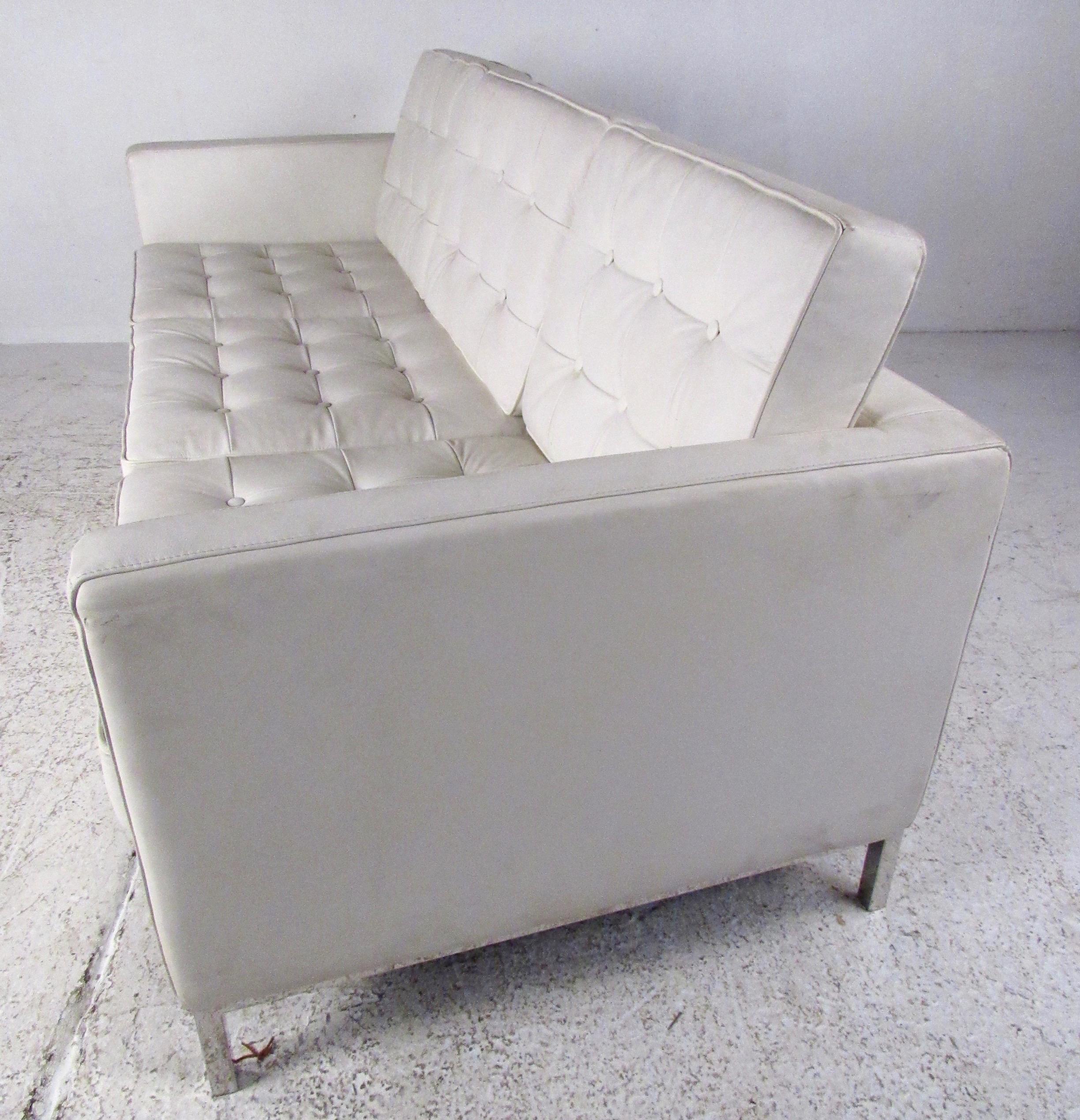 This three-seat modern sofa features chrome finish frame with tufted vinyl upholstery. Distinctive sofa in the style of Florence Knoll is the perfect size for apartment living or office seating. Please confirm item location (NY or NJ).