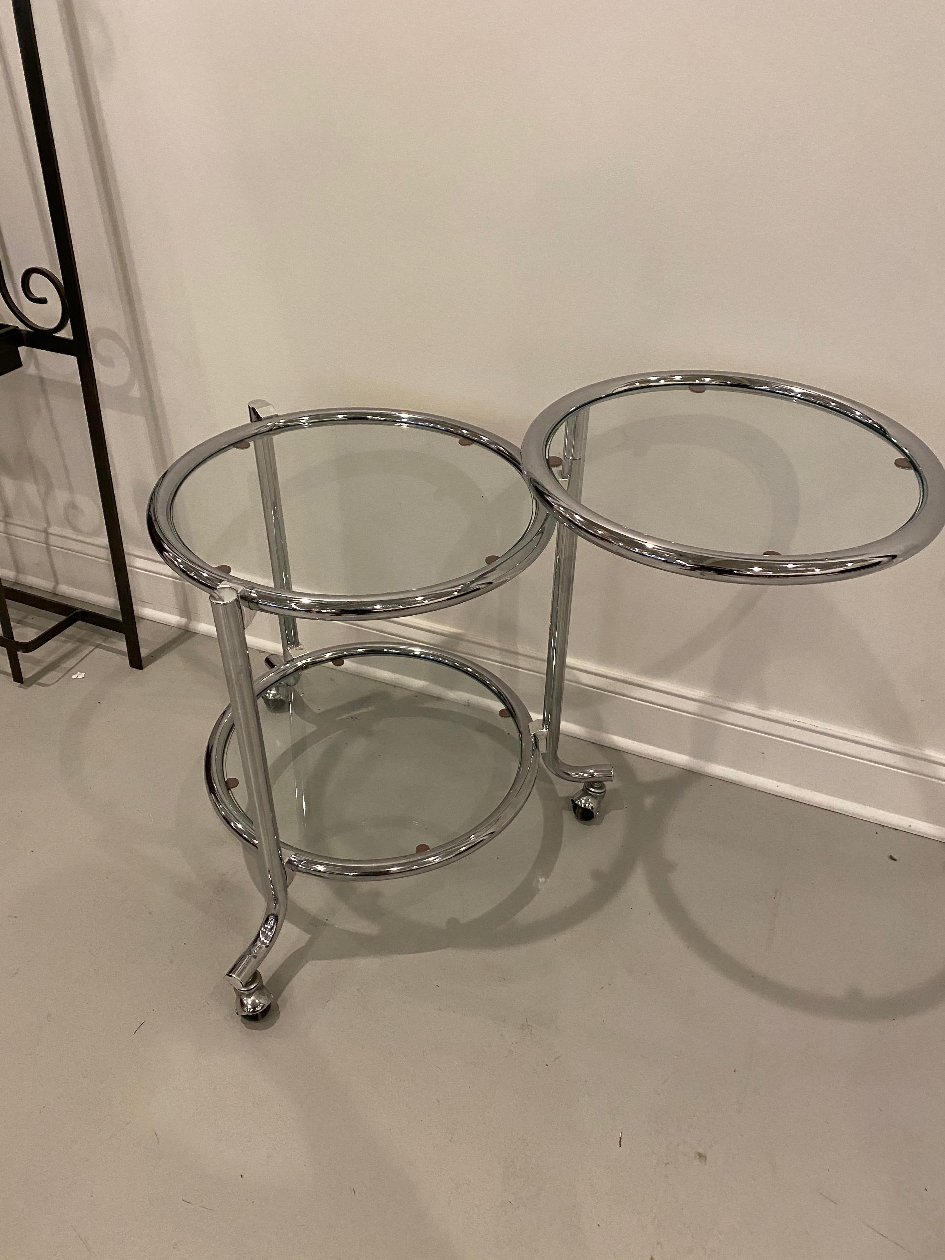 Modern three tiered glass side table. The top round glass tier swings 360 degrees.