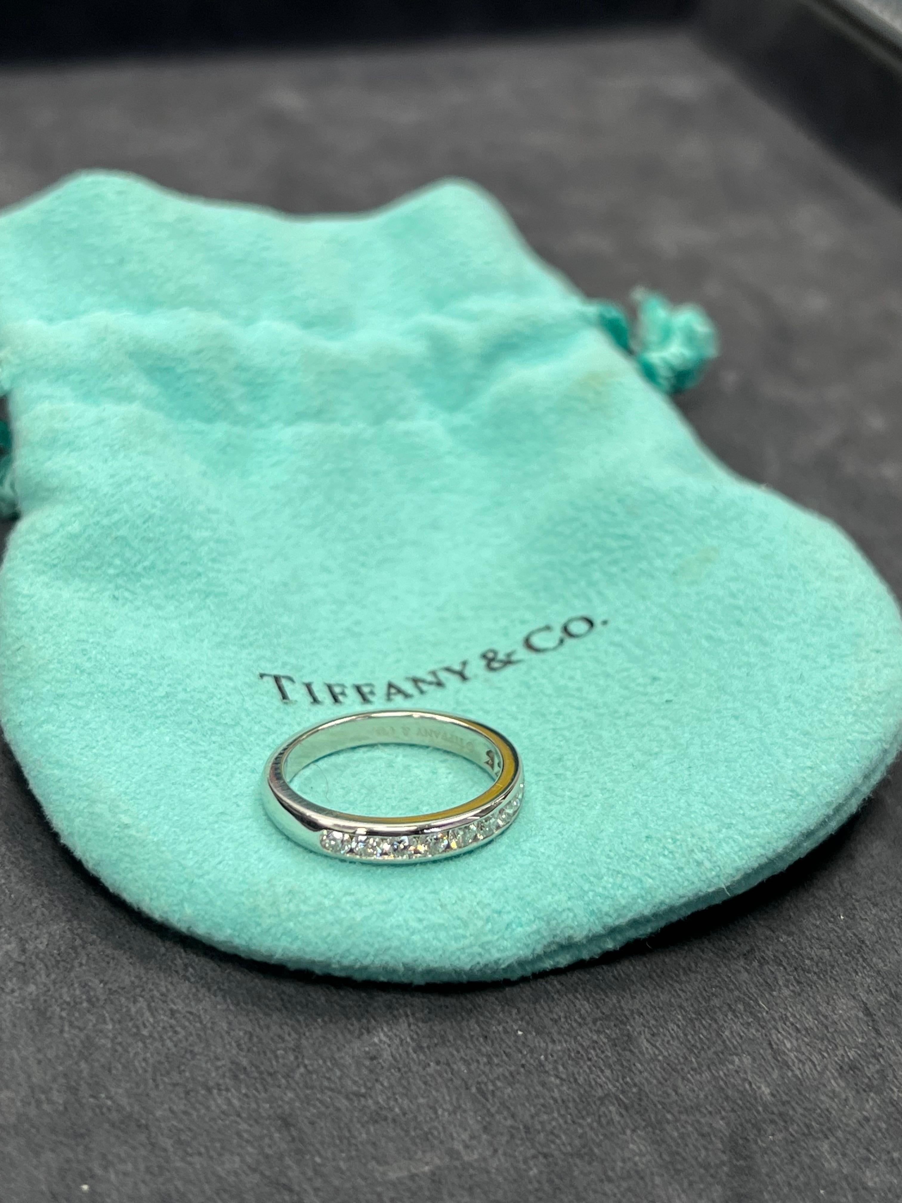 Authentic Tiffany & Company Platinum Band Channel set with 11 colorless round brilliant diamonds weighing a total of 0.17 carats. 

Ring size is 5.5 and total weight is 4.7 grams. Original Pouch included. No box, no papers.

As of September 14, 2023
