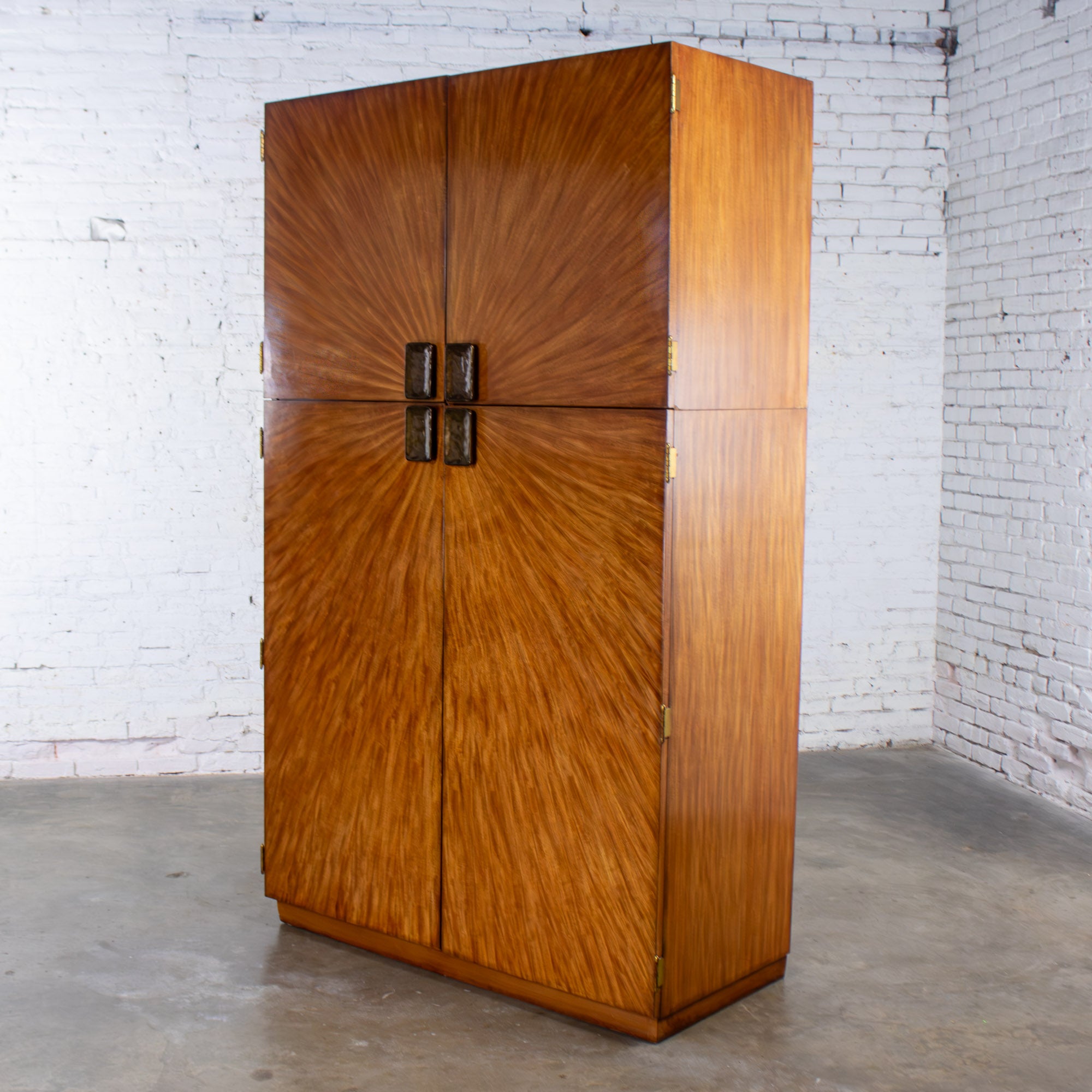 Marvelous Late 20th Century Modern to Art Deco Revival Entertainment Arbus Armoire 6000 Series by Henredon composed of 2 piece top 
lower sections with book matched burl wood frames, cast bronze pulls, 2 removeable 
adjustable wood