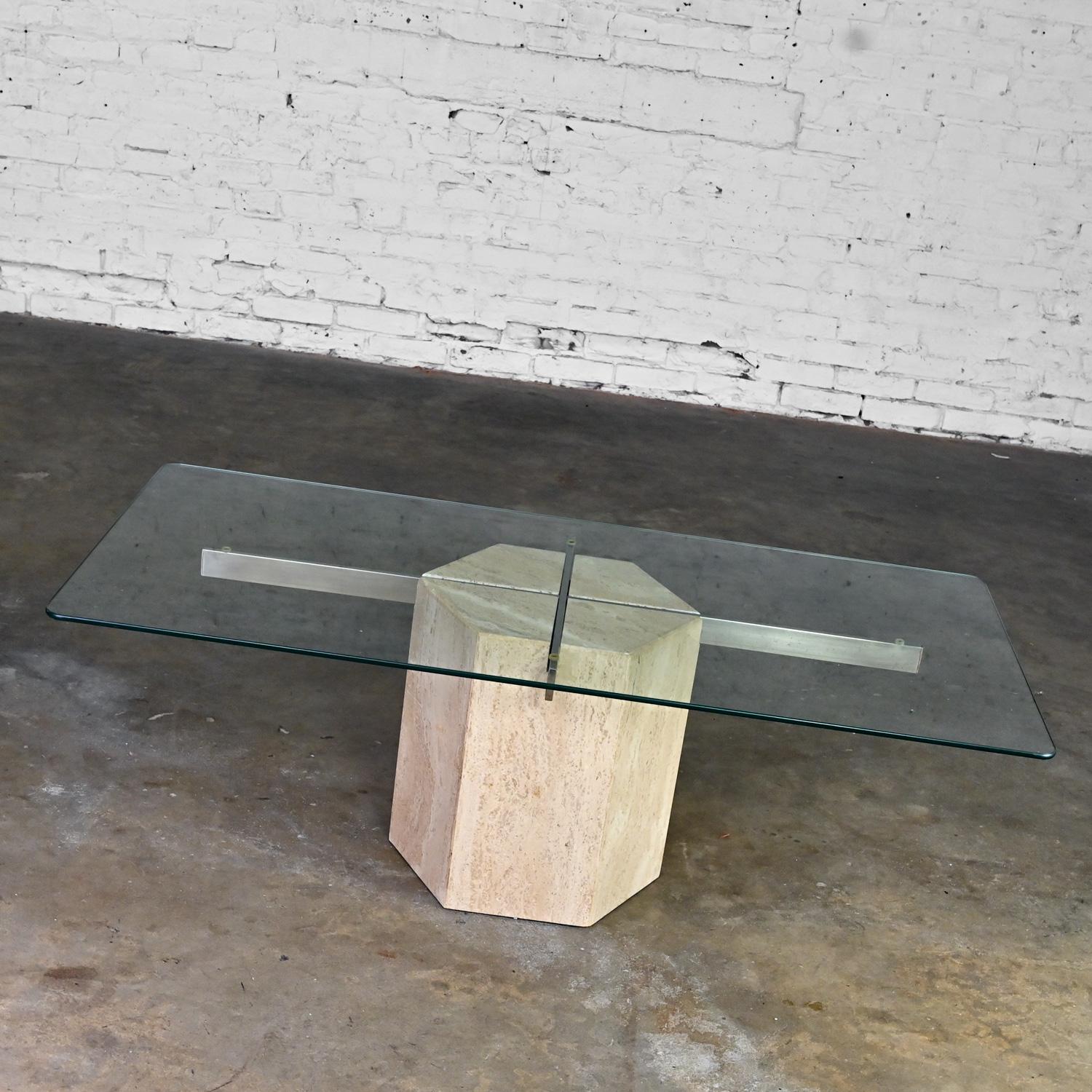 Lovely vintage Modern to Postmodern Italian coffee table comprised of a hexagon shaped travertine pedestal base, rectangular chrome tube details, and a rectangular glass top in the style of Artedi. Beautiful condition, keeping in mind that this is