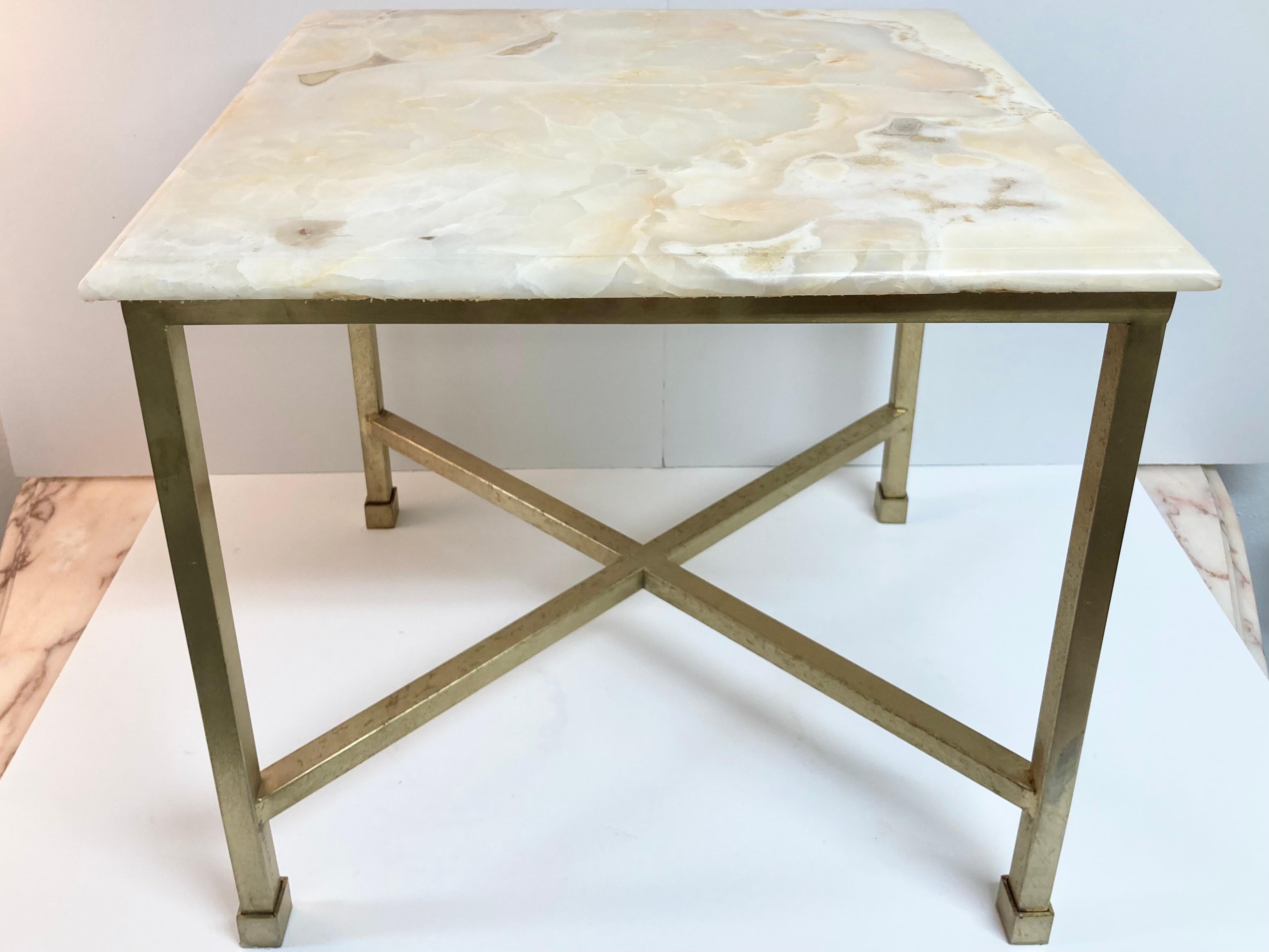 Single Todd Hase designed Christelle cocktail table with bianco onyx top and bronze base. This is a gallery sample from the 2010s. Typical gallery condition. We have 2 available listings. They would be a great pair as a coffee table in front of a