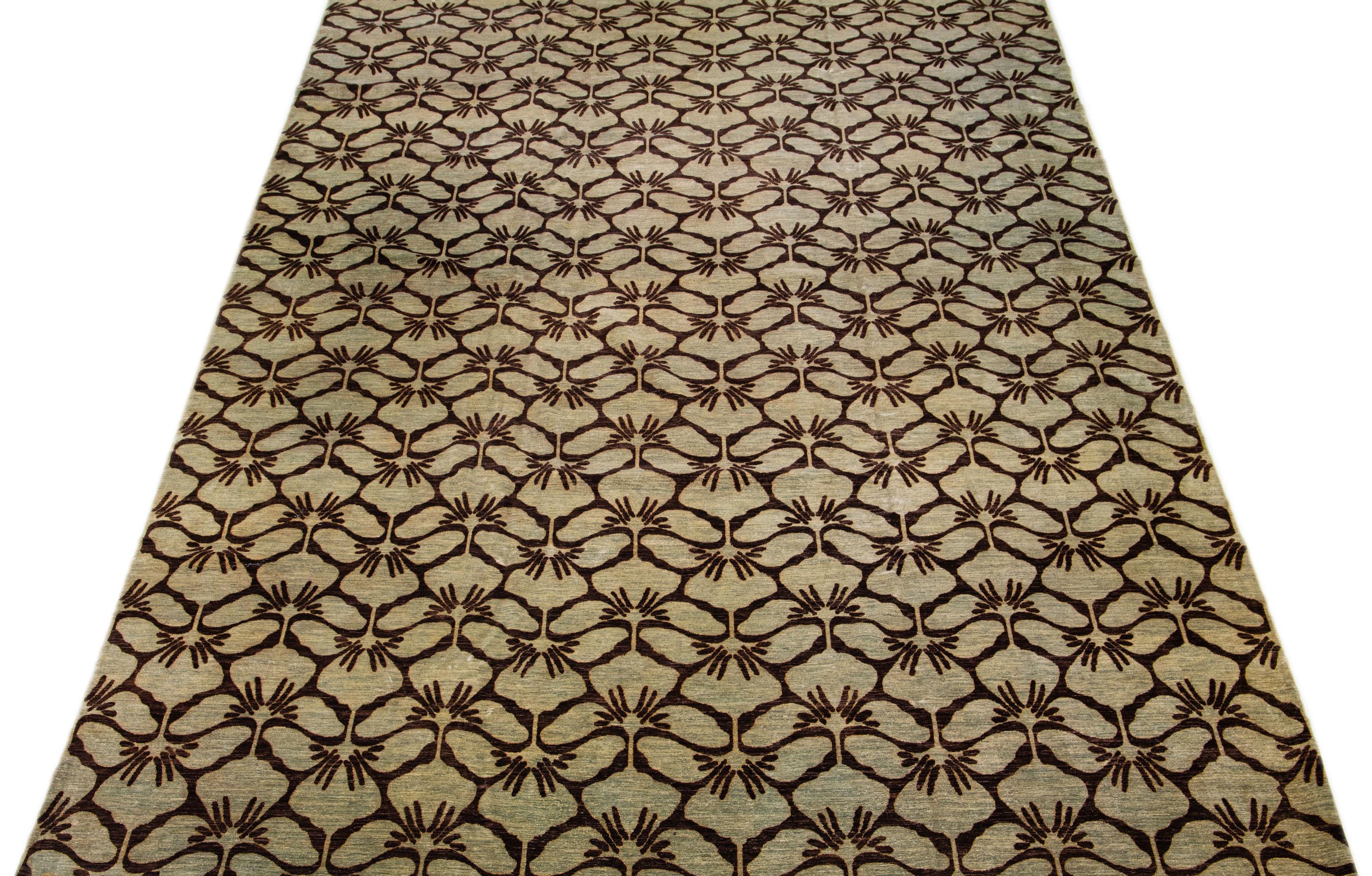Beautiful modern hand-knotted wool rug with a tan field. This Transitional rug has a brown accent to create a modern, palmettes pattern design with a mid-century look. 

This rug measures: 13' x 20'1