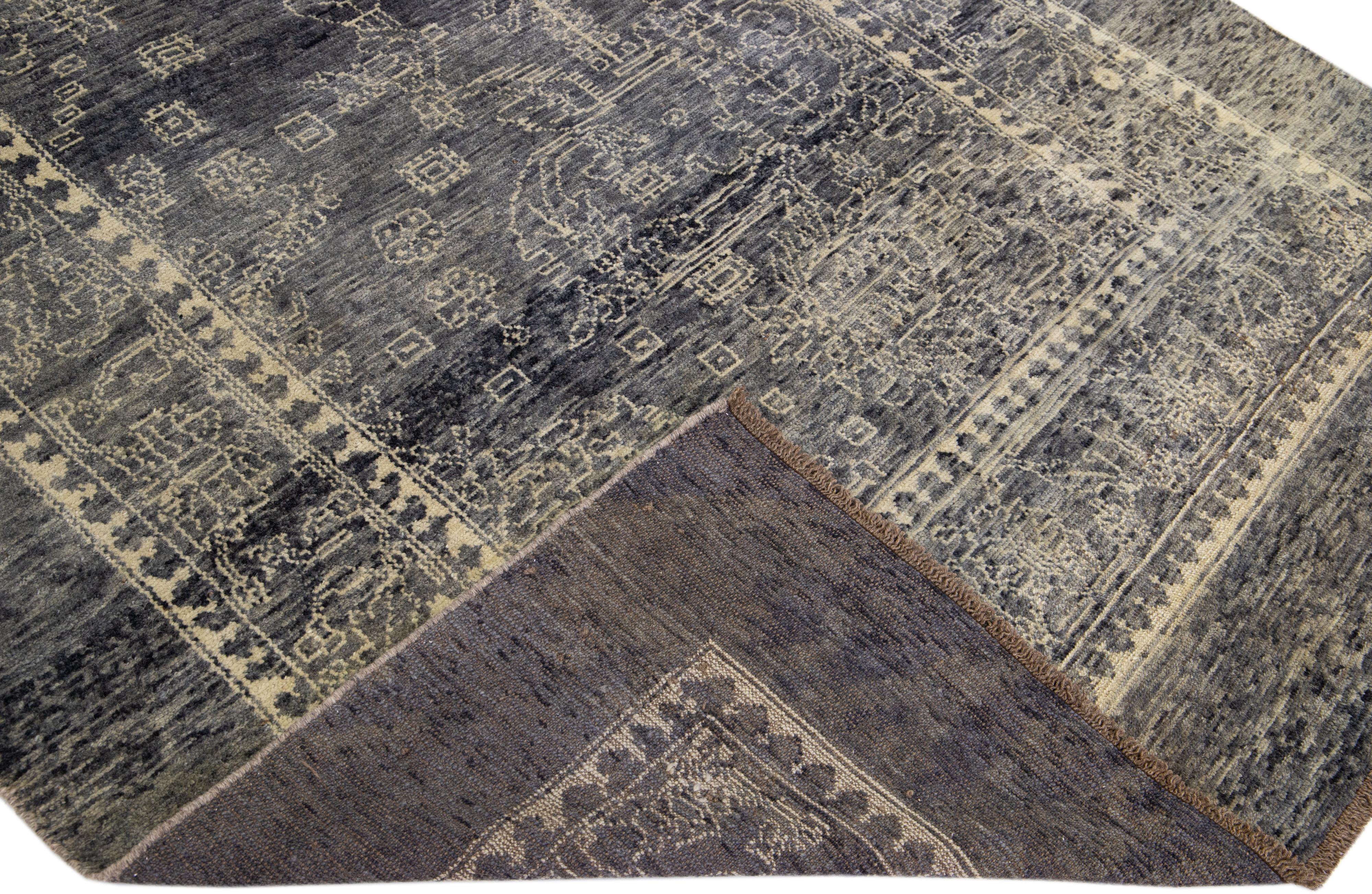 This Beautiful transitional handmade wool rug makes part of our Northwest collection and features a gray color field and beige accents in a gorgeous all-over geometric design.

This rug measures: 6'5