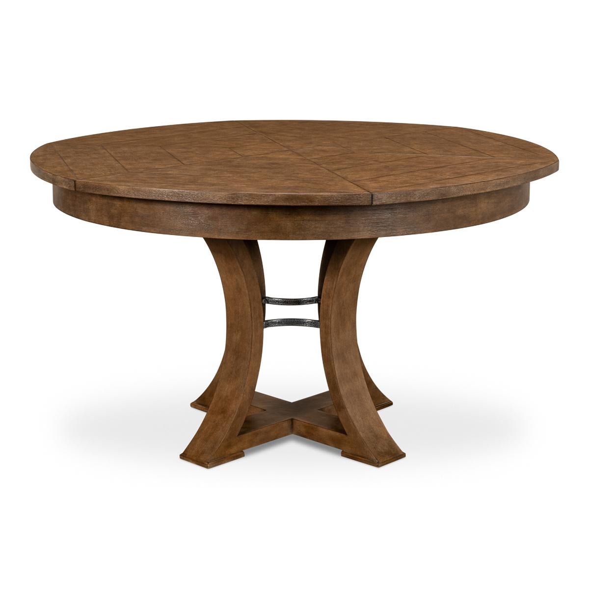 A modern transitional style round extending dining room table. Warm acacia wood top in our muted fossil finish with iron supports to the simple geometric form base. The table opens and extends to 70
