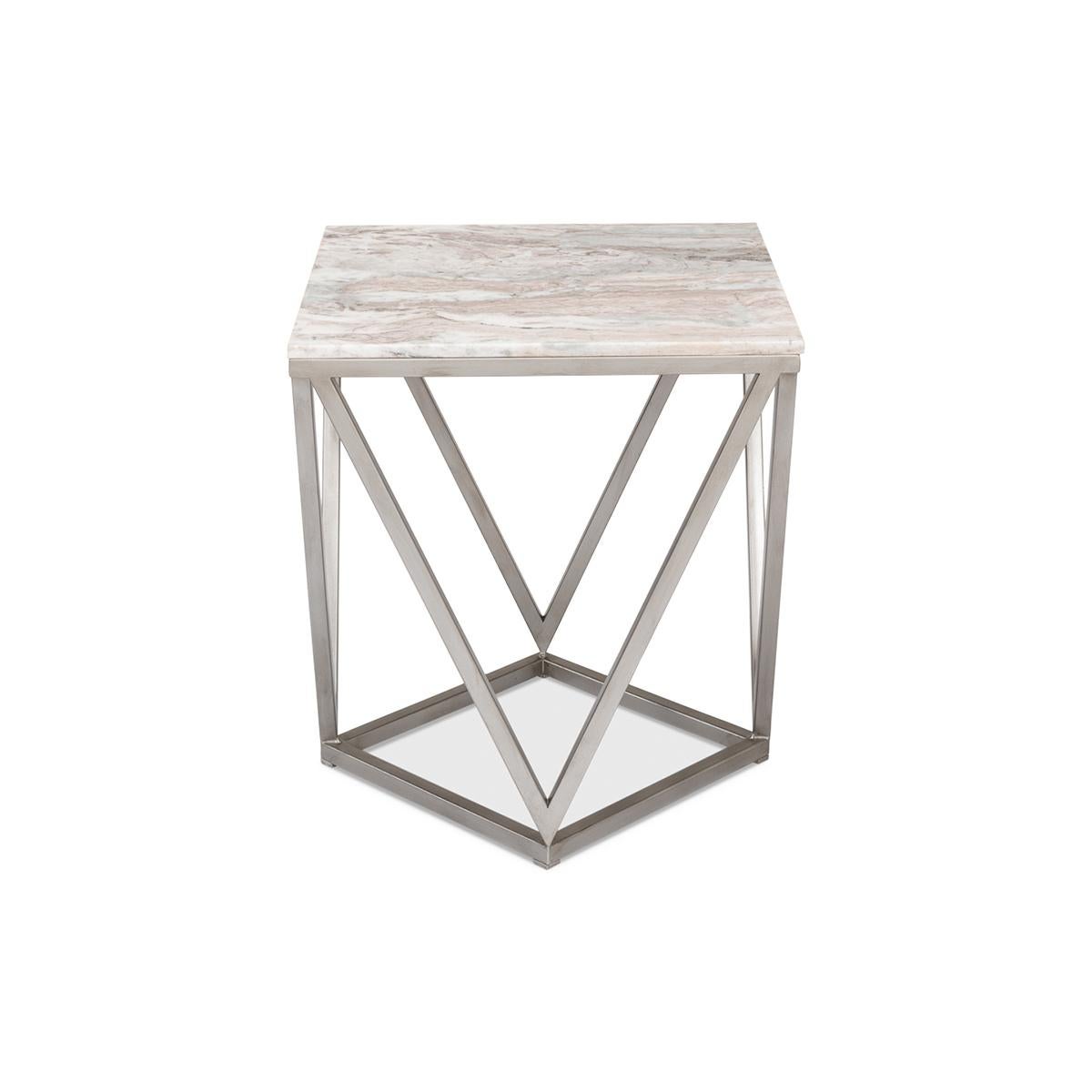 An unusual geometrically inspired silvered iron base with a square marble top.

Dimensions: 20