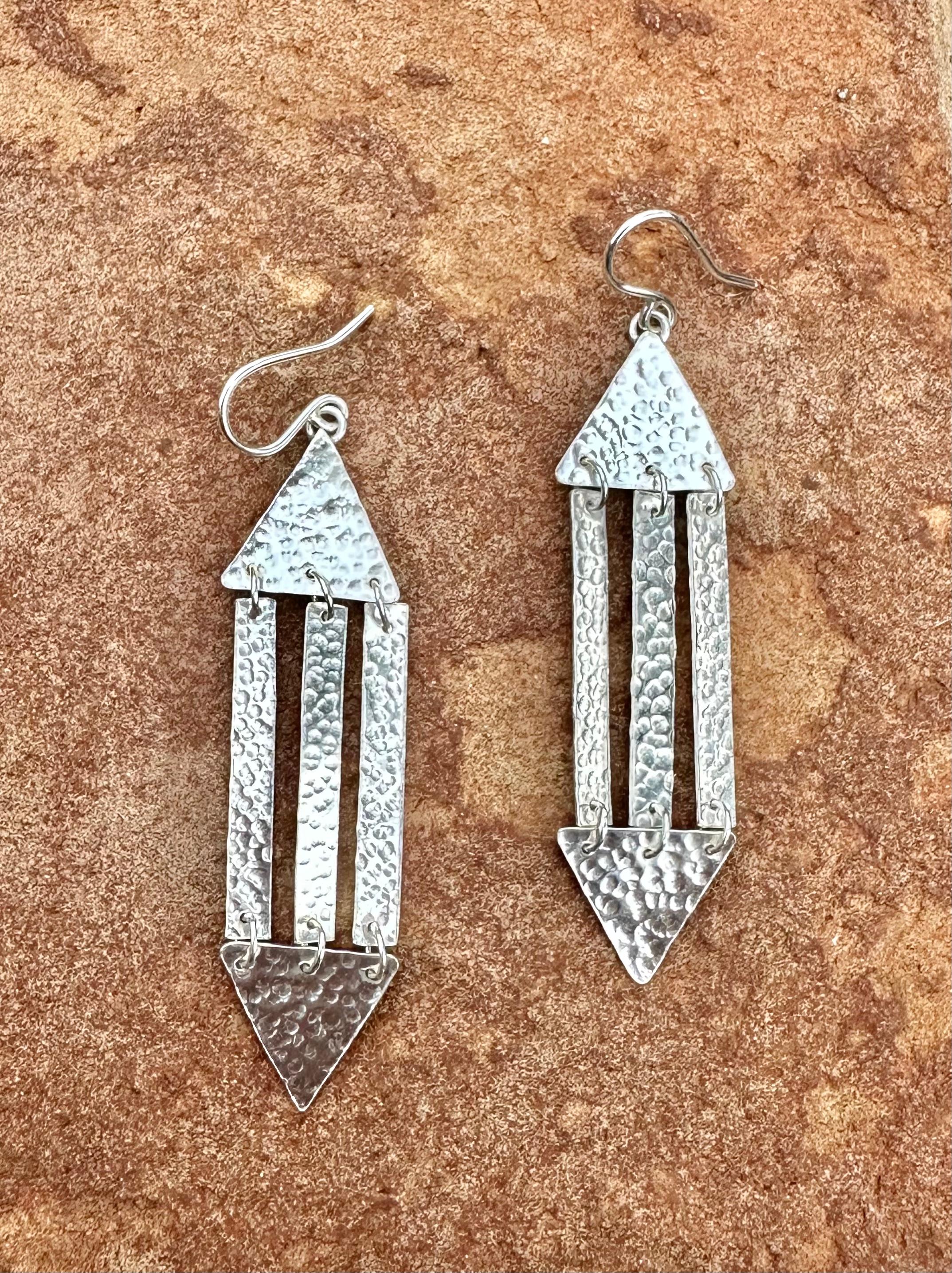 -Available
-Handmade
-Sterling silver
-Stamped with Nebu logo

Introducing our sleek and stylish triangle modern earrings, handcrafted in sterling silver. These earrings are designed with a contemporary flair, featuring a minimalist triangle shape
