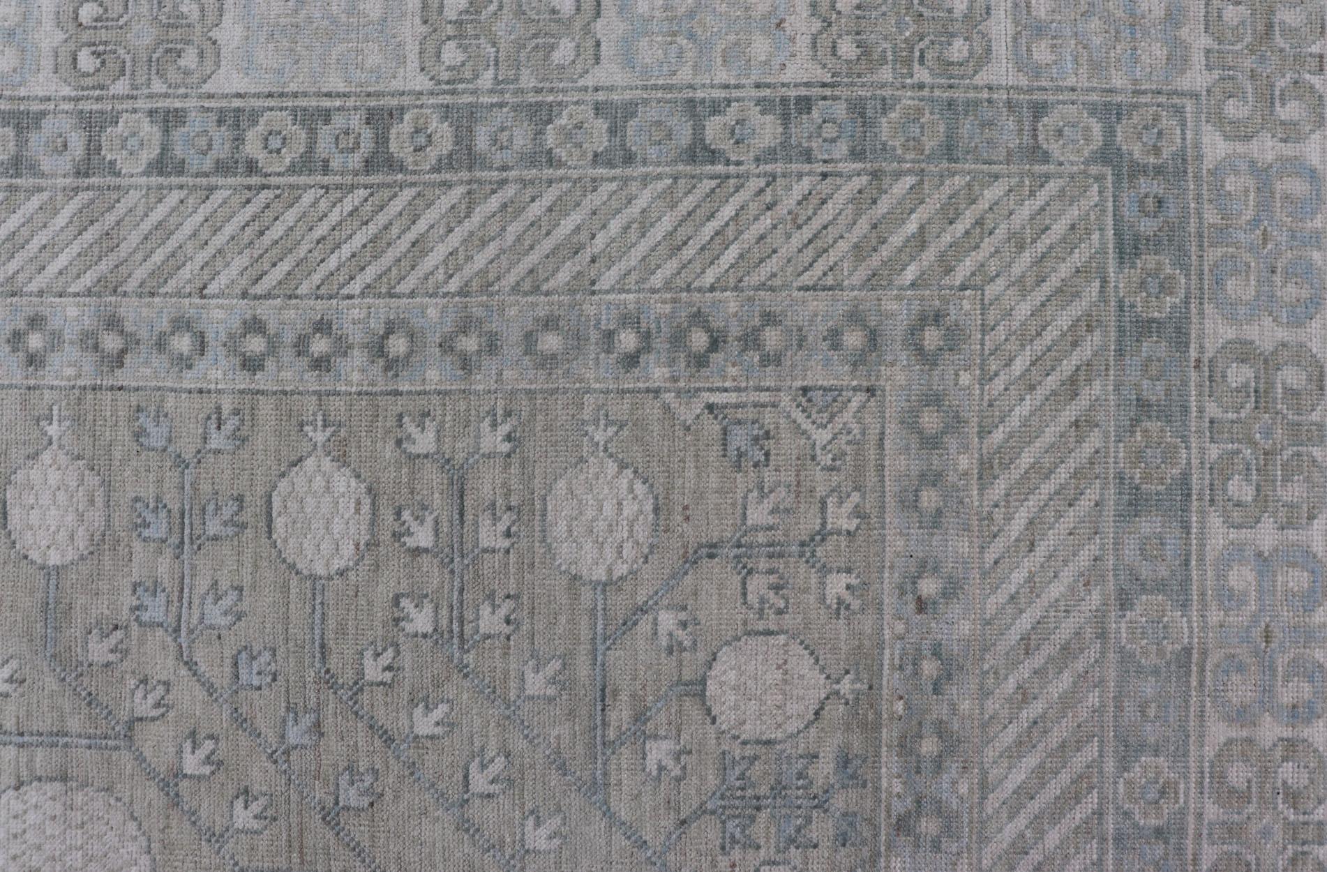 Measures: 8'2 x 10'4 
Modern Tribal Khotan rug in shades of cream. Green, blue, and gray. Keivan Woven Arts Country of origin; Afghanistan Type: Khotan Keivan Woven Arts; rug AWR-15227, early 21st century.

This modern Khotan features a modern muted