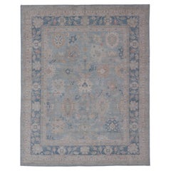 Modern Tribal Oushak with a Blue Border and Light Gray-Blue Background