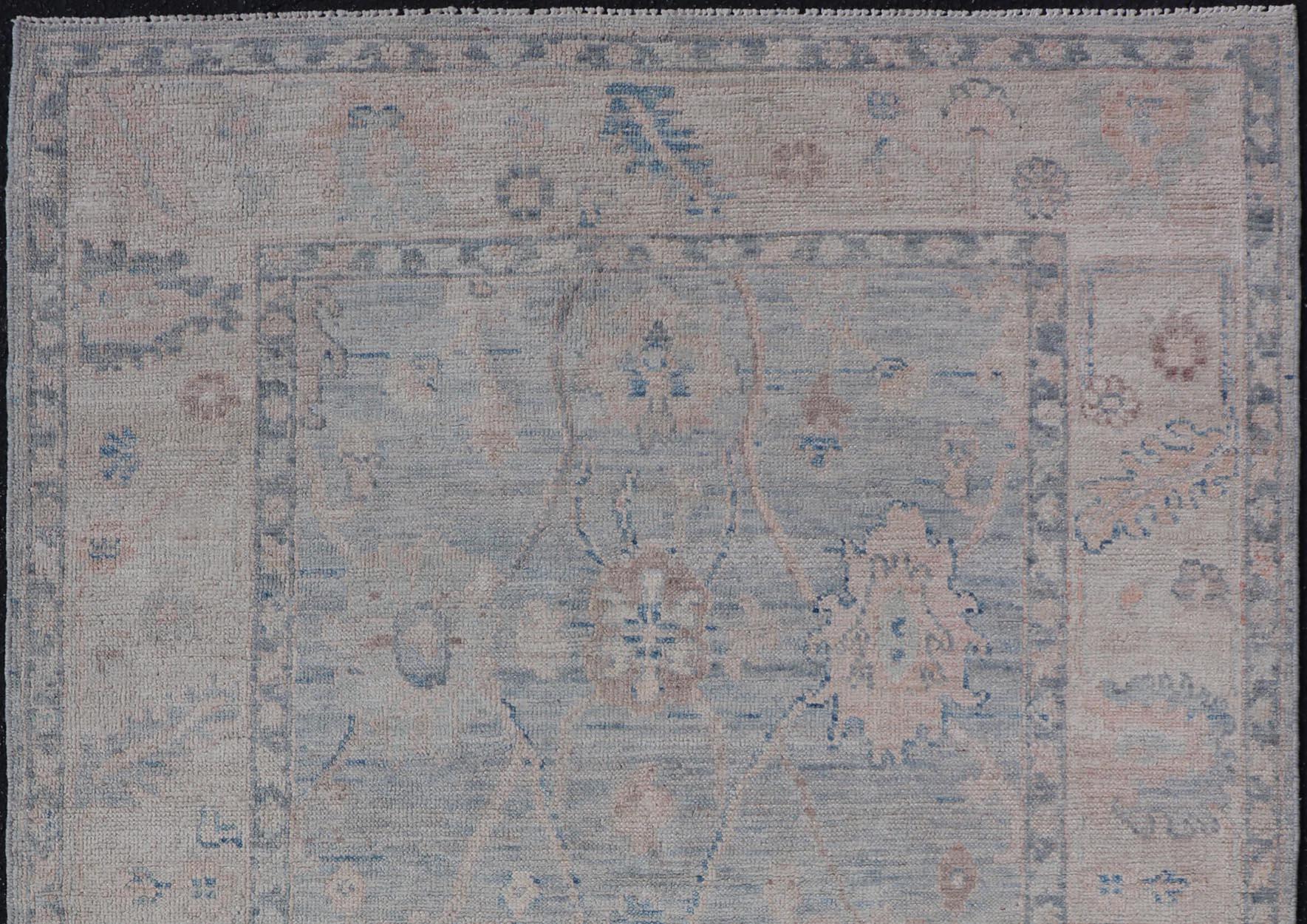 Modern Tribal Oushak With A Cream Border and Light Cool Gray-Blue Background. Country of Origin: Afghanistan; Type: Oushak; Design: Medallion, Tribal Medallion, All-Over; Keivan Woven Arts: rug AWR-8478
Measures: 4'0 x 6'2 
 A Oushak featuring
