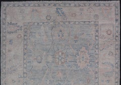 Modern Tribal Oushak with a Cream Border and Light Gray-Blue Background