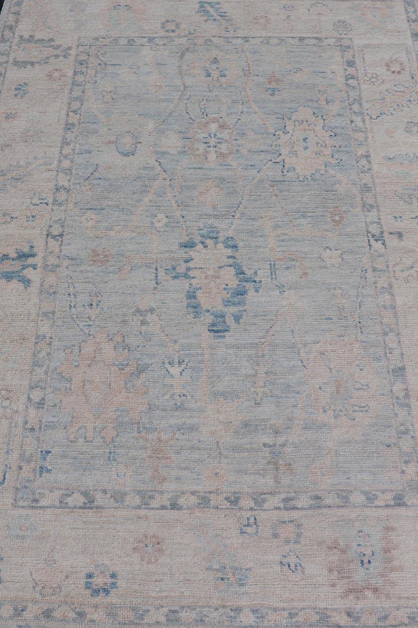 Modern Tribal Oushak with a Cream Border and Light Gray-Blue Background In New Condition For Sale In Atlanta, GA