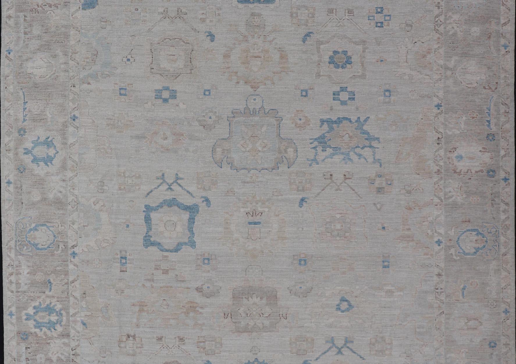 Modern Tribal oushak with light taupe colored border and off white background Country of Origin: Afghanistan; Type: Oushak; Design: Medallion, Tribal Medallion, All-Over; Keivan Woven Arts: rug AWR-9045; Authentic Oushak, 

Measures: 9'4 x 11'10