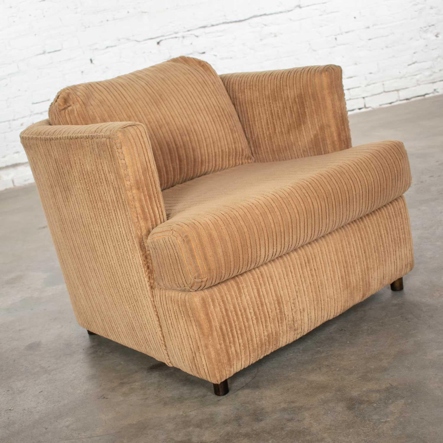 Wonderful modern wide wale corduroy upholstered tub shaped club lounge chair in the style of Harvey Probber. Original upholstery and walnut cylindrical feet. Beautiful age appropriate condition. It has been professionally cleaned and can be used as